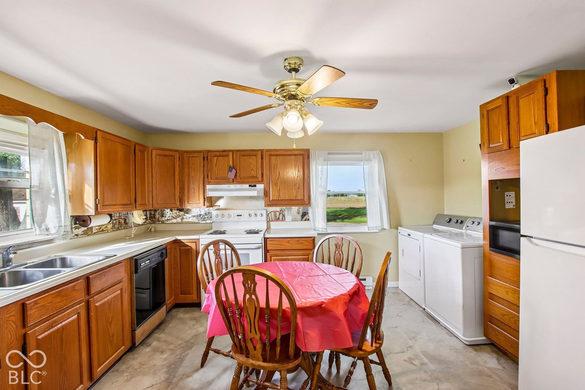 4469 E 400 S, Franklin, IN 46131 Kitchen featuring wood cabinetry, integrated oven and stovetop, dual-basin stainless steel sink, and ceiling-mounted light fixture