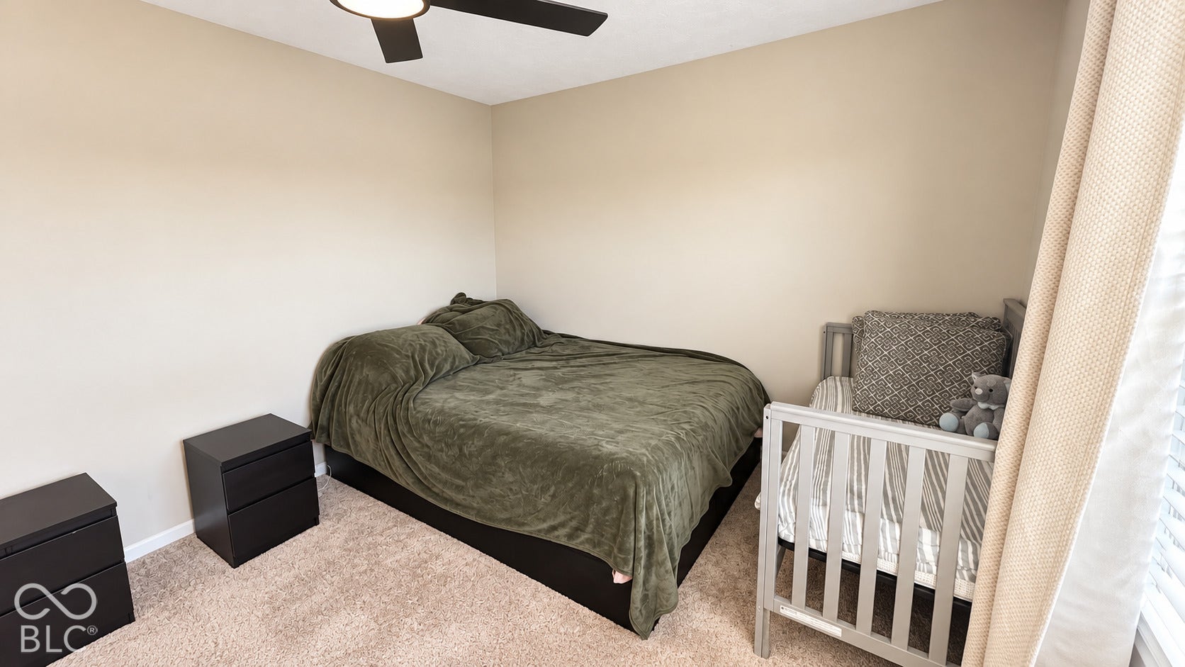 Room featuring neutral wall tones, plush wall-to-wall carpeting, and a modern ceiling fan with integrated lighting