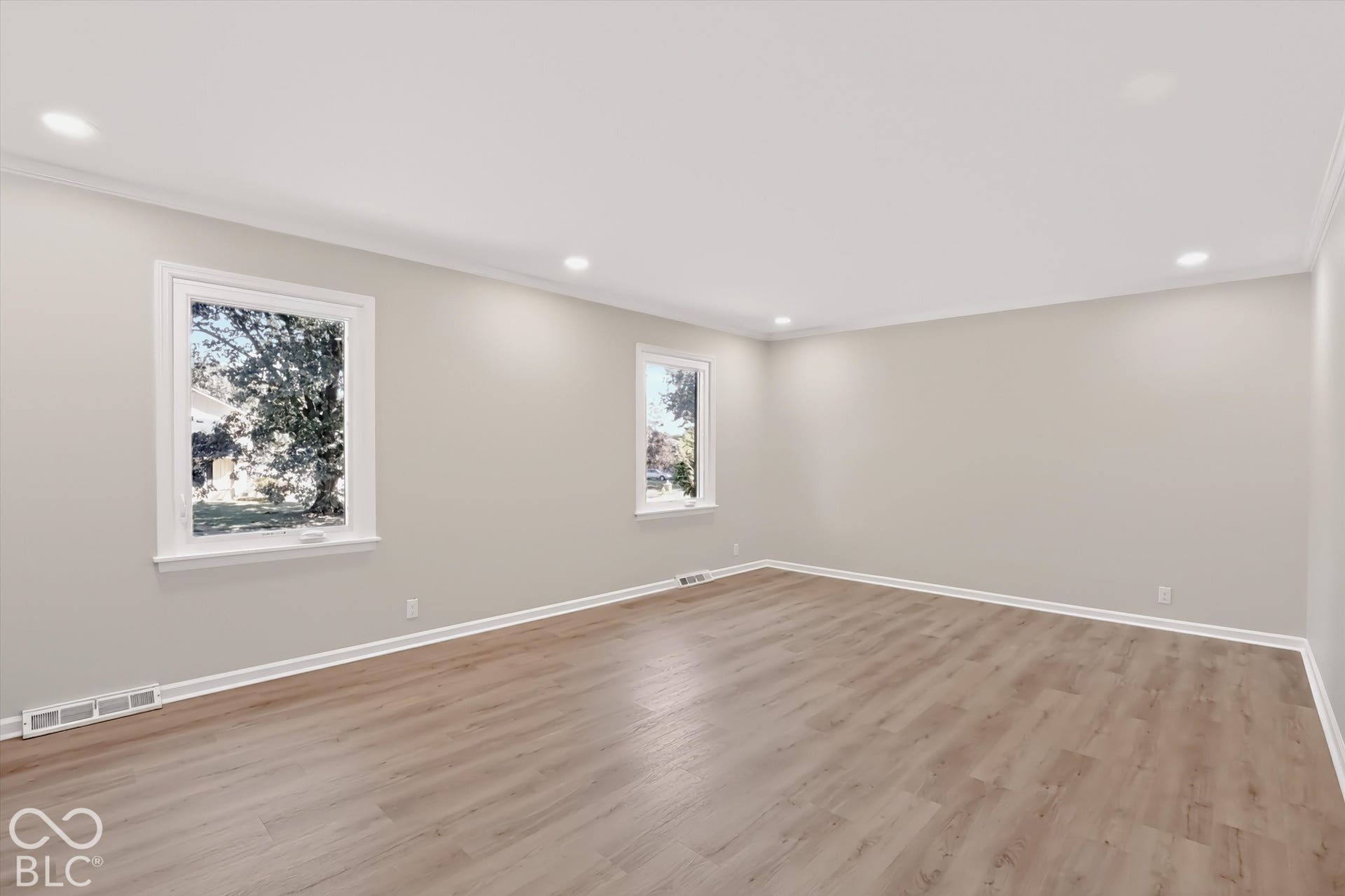 Neutral interior space featuring wood-finish flooring, recessed lighting, and double-pane windows