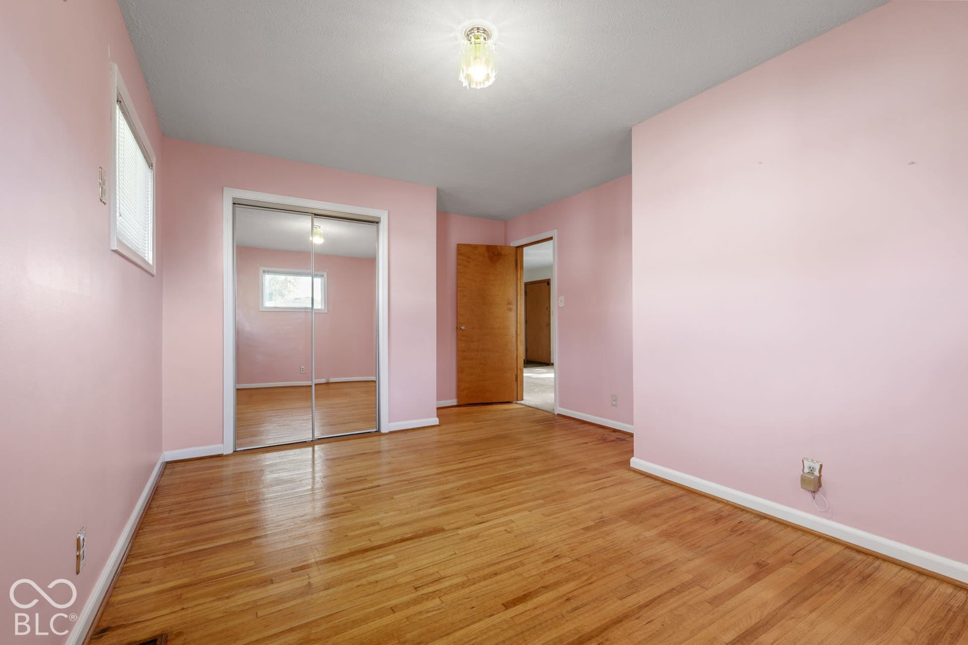280 Anniston, Indianapolis, IN 46227 Interior space featuring wood-finish flooring, mirrored sliding closet doors, and a wood-panel door