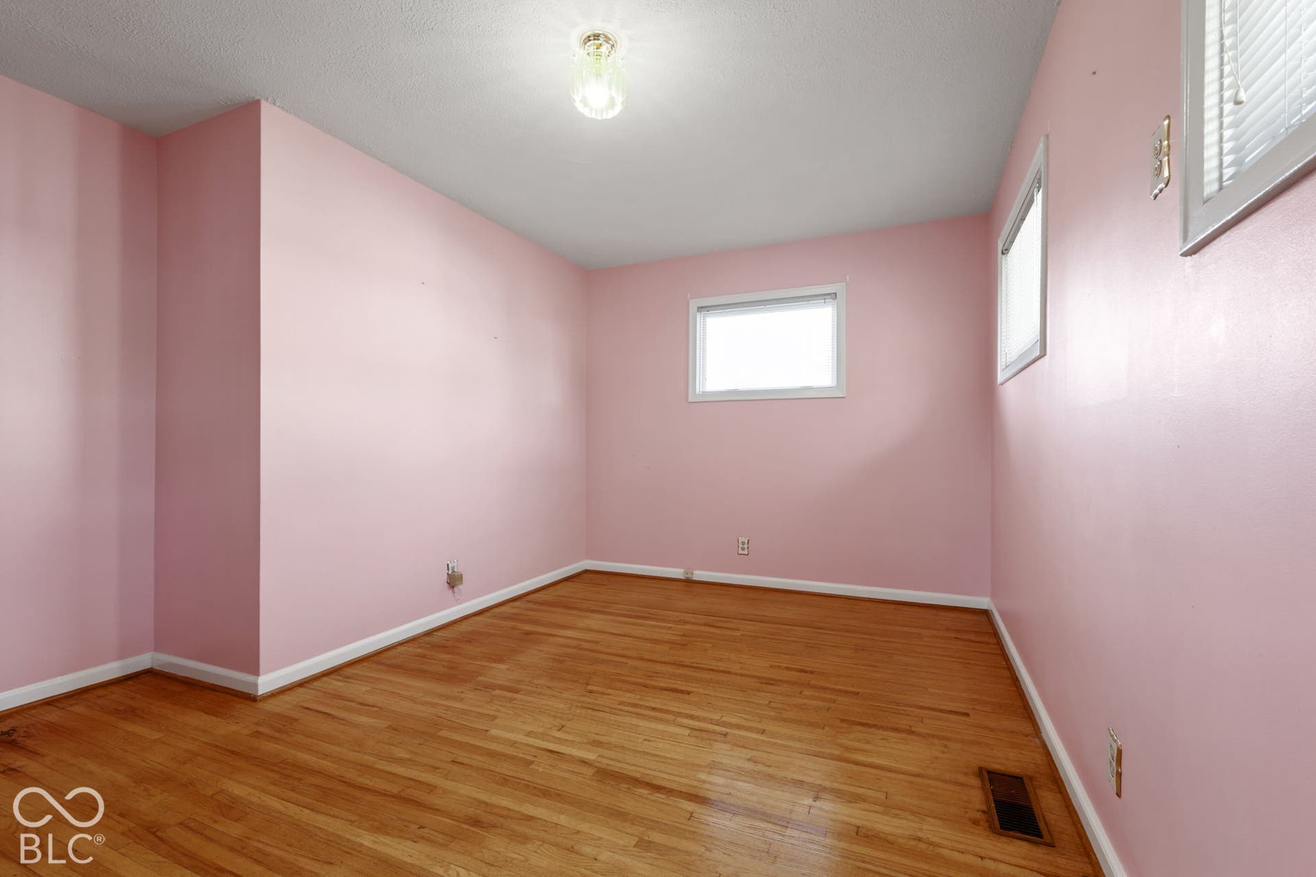 280 Anniston, Indianapolis, IN 46227 Interior room featuring wood-finish flooring, white-framed windows, and a central ceiling light fixture
