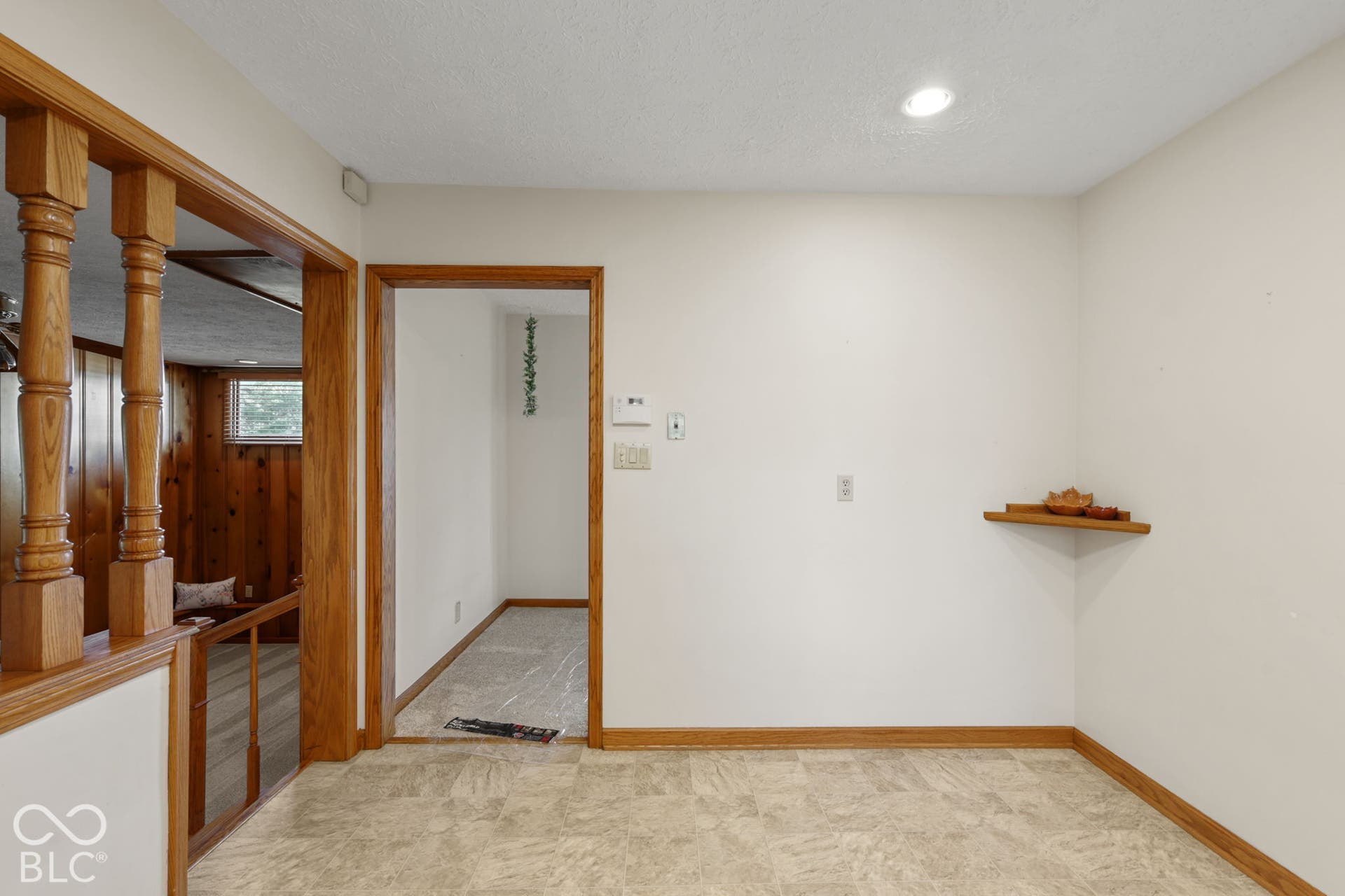 280 Anniston, Indianapolis, IN 46227 Interior space featuring natural wood-finish trim, decorative turned-wood balusters, recessed lighting, and a built-in corner display shelf