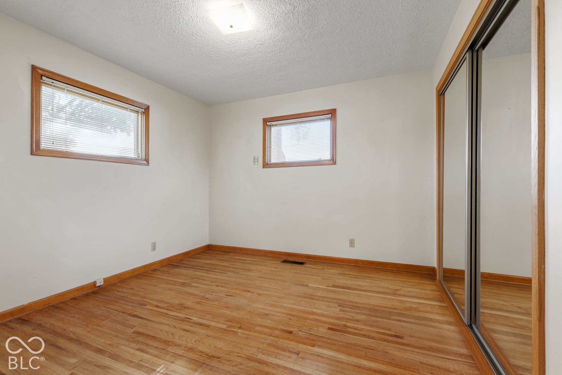 280 Anniston, Indianapolis, IN 46227 Wood-finish flooring, sliding mirror-panel closet doors, natural wood window trim, and ceiling-mounted lighting