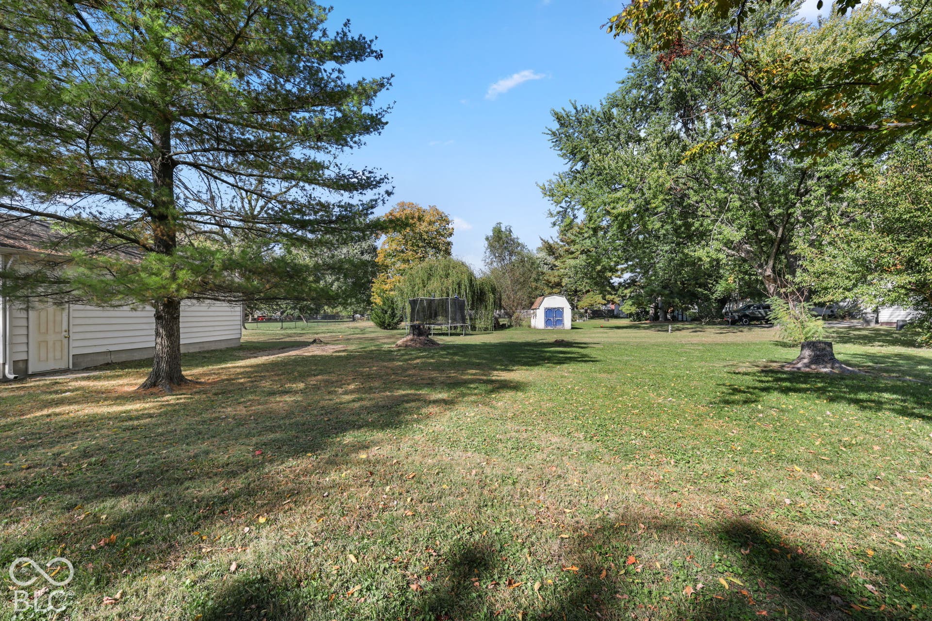280 Anniston, Indianapolis, IN 46227 Expansive backyard featuring a large grass lawn, mature trees, and a detached storage structure