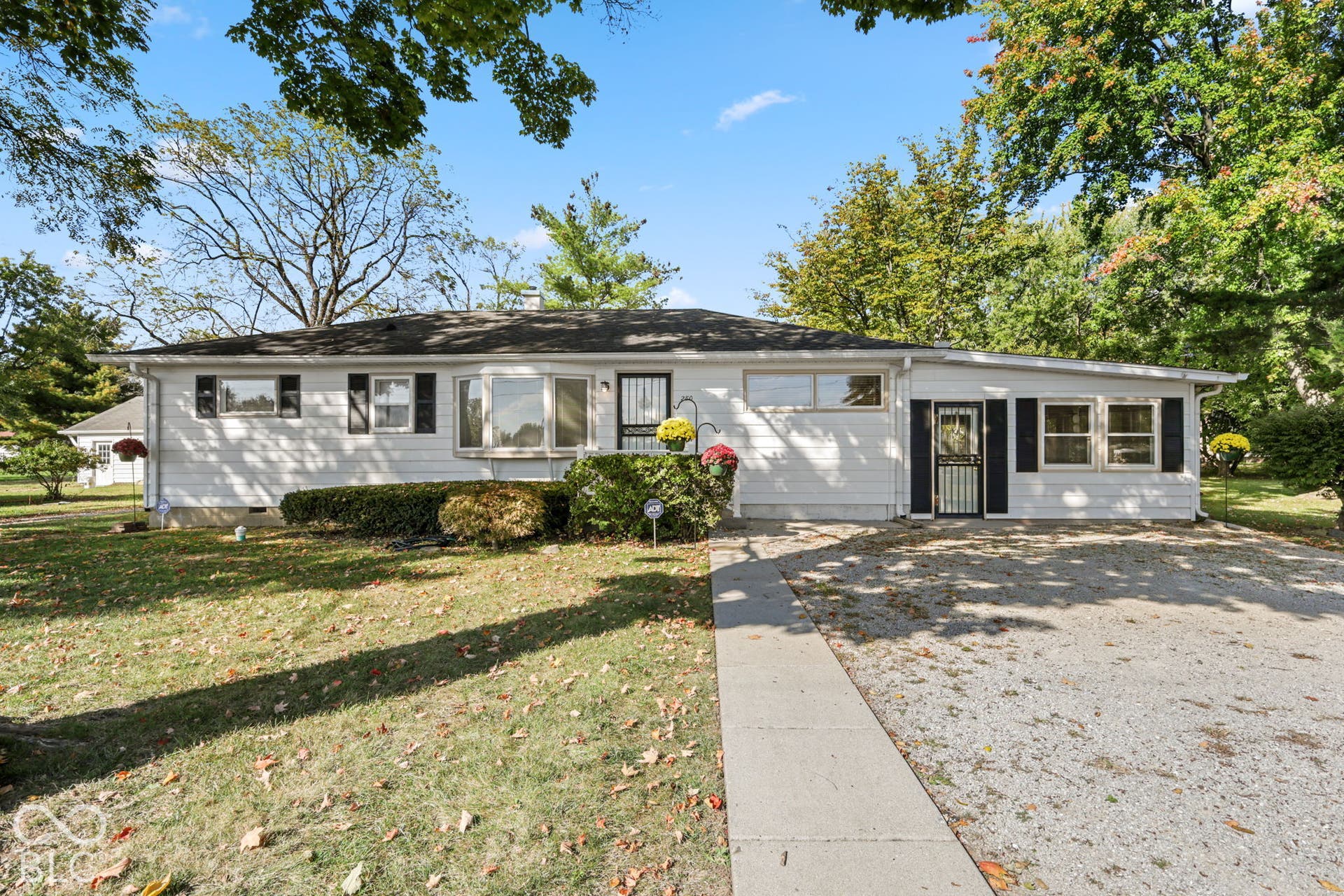 280 Anniston, Indianapolis, IN 46227 Single-story exterior featuring white horizontal siding, dark decorative shutters, a central bay window, and a concrete walkway
