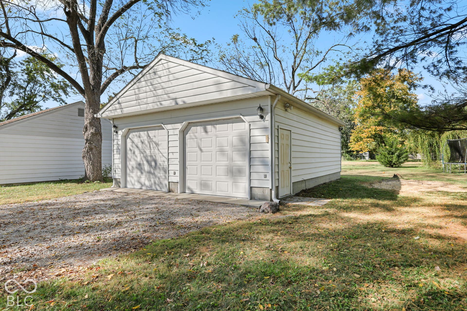 280 Anniston, Indianapolis, IN 46227 Detached two-car garage featuring vinyl siding, gable roofline, two paneled overhead doors, and exterior wall-mounted lighting