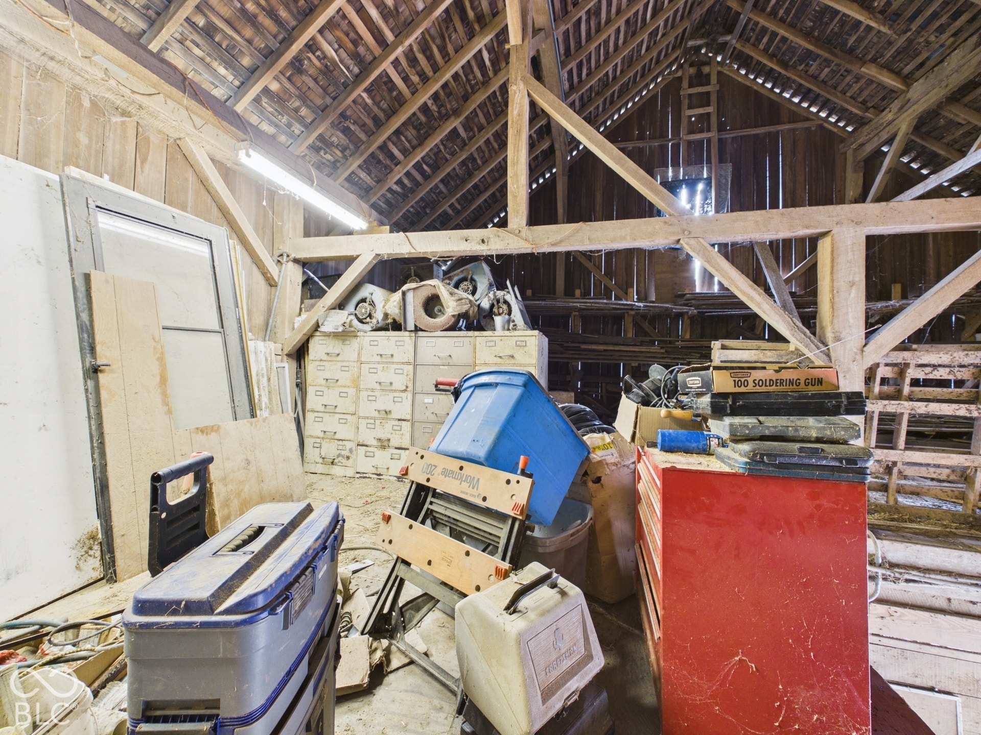 Exposed timber framing and rustic wood plank walls featuring a high vaulted roof structure