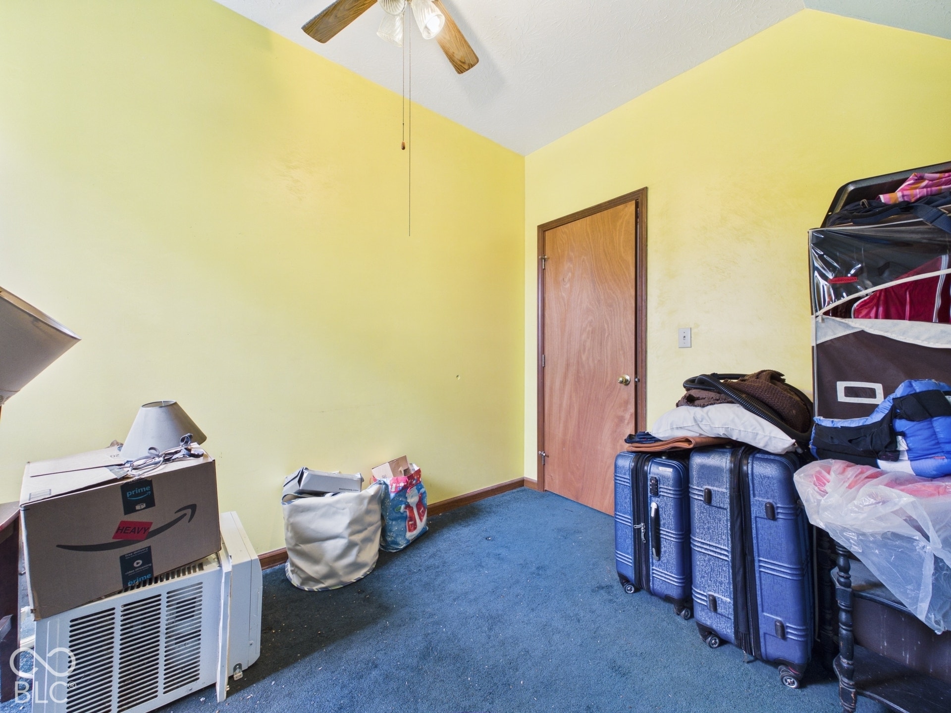 Room featuring vaulted ceilings and a ceiling-mounted fan