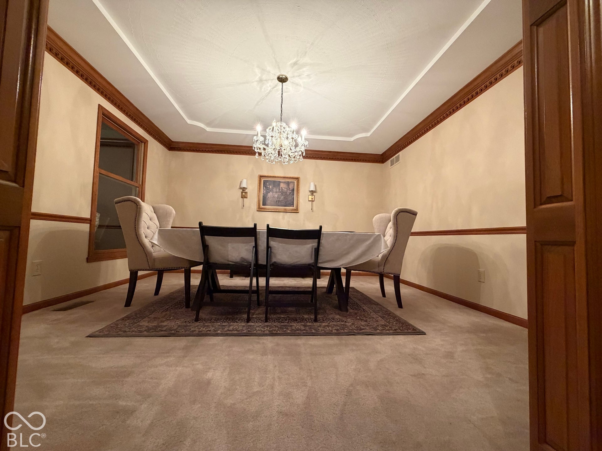 Formal dining room with trey ceiling, chair rail, gorgeous custom crown moulding and dentil mounding (chandelier will be replaced).