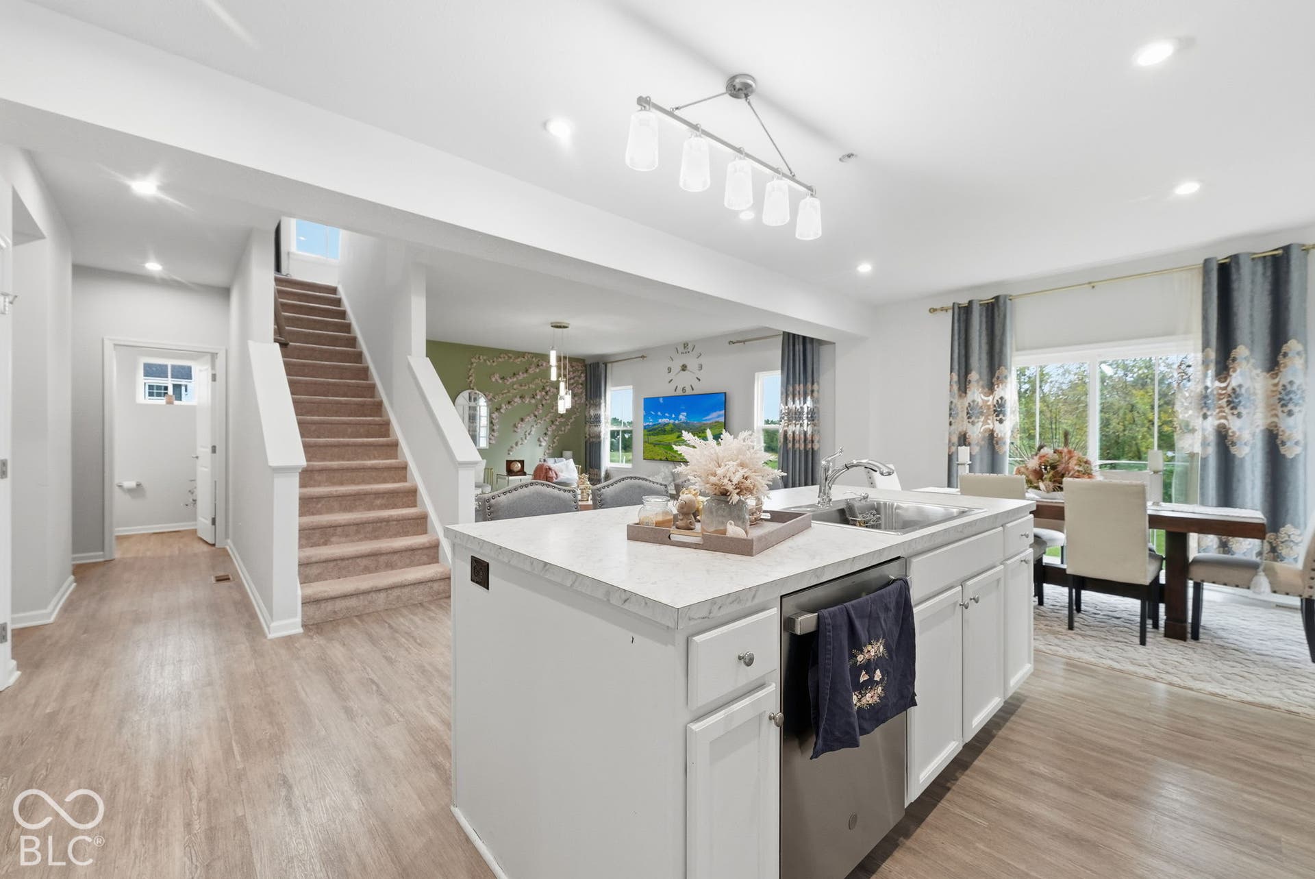 275 Bohicket Road, Whiteland, IN 46184 Kitchen island featuring a solid surface countertop, stainless steel undermount sink, and stainless steel dishwasher