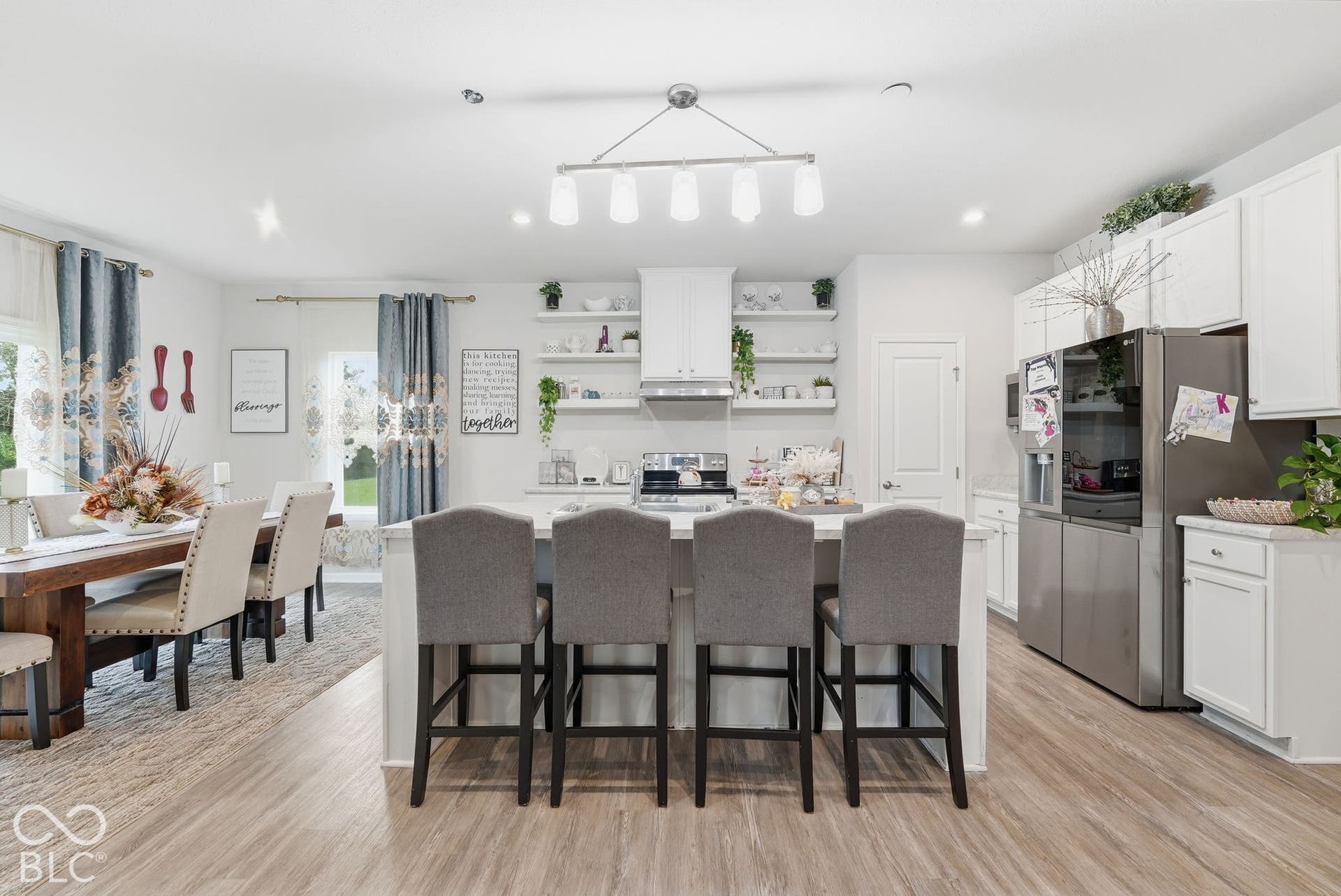 275 Bohicket Road, Whiteland, IN 46184 Kitchen featuring white cabinetry, wood-finish flooring, a central island, floating shelving, and stainless steel appliances