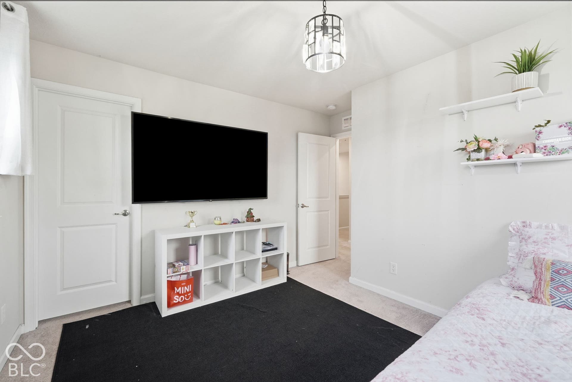 275 Bohicket Road, Whiteland, IN 46184 Neutral interior featuring two panel doors, wall-mounted shelving, and a tiered metal cage pendant light fixture