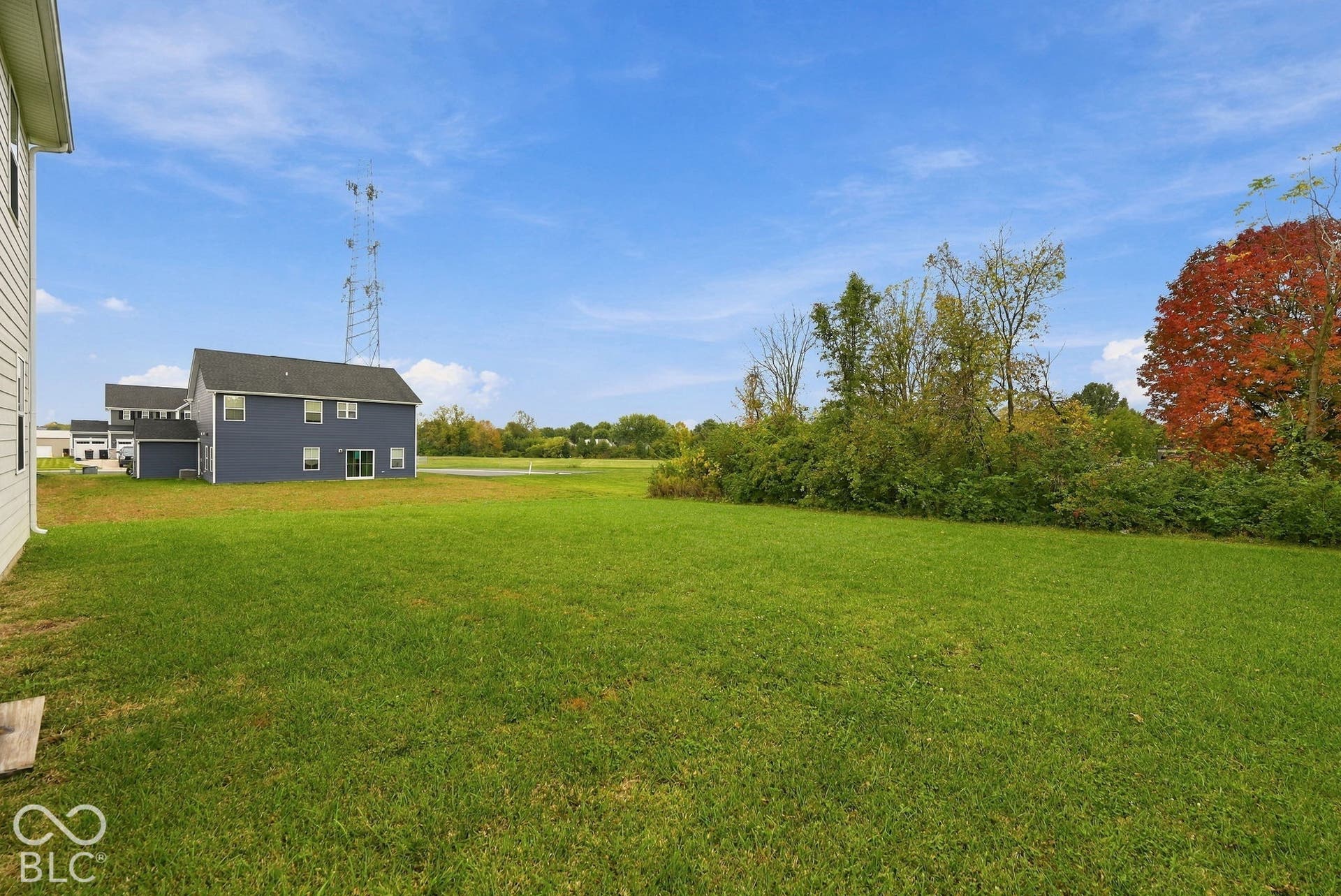 275 Bohicket Road, Whiteland, IN 46184 Expansive backyard featuring a large grass lawn, mature trees, and open sky