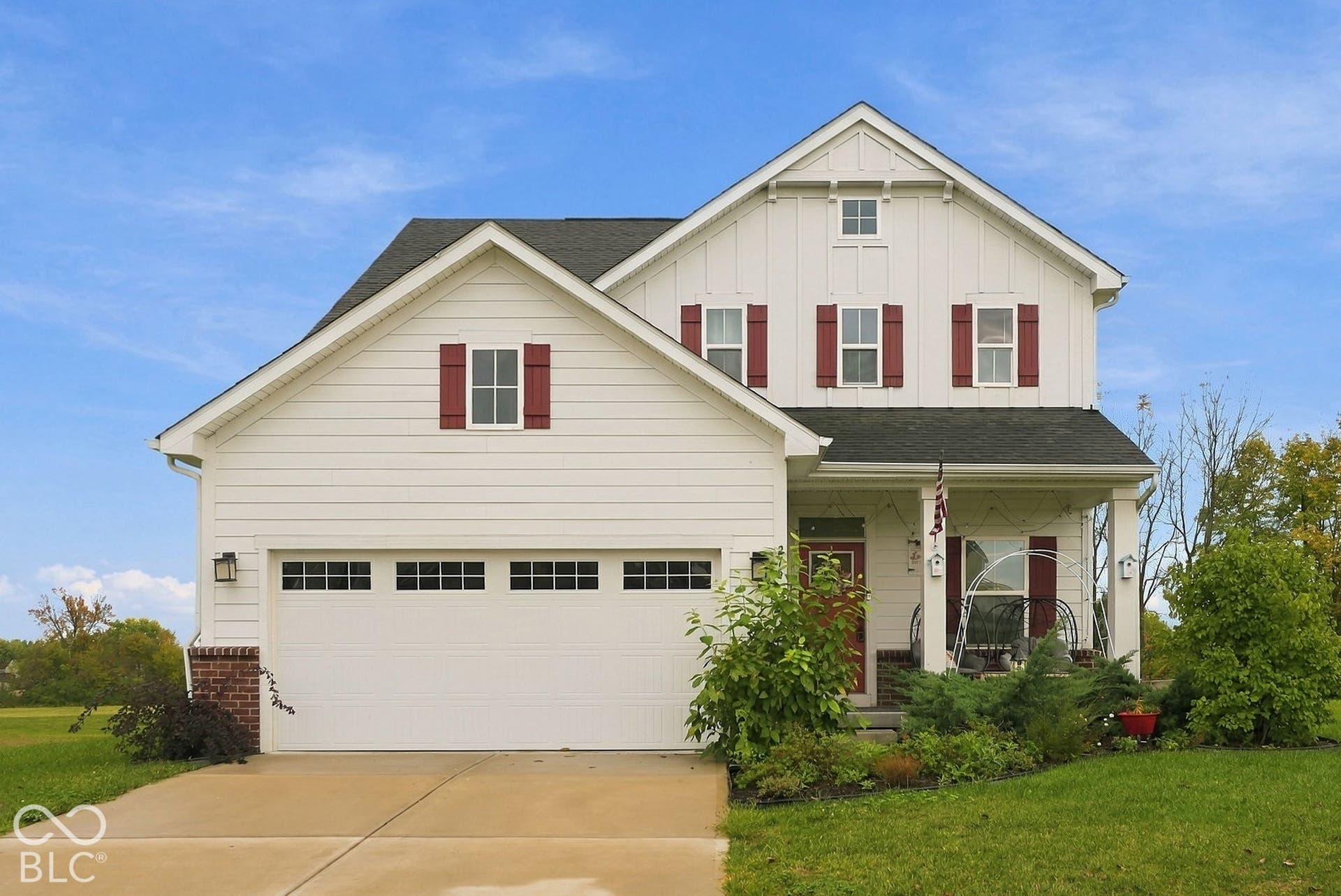 275 Bohicket Road, Whiteland, IN 46184 Two-story exterior featuring white horizontal lap and vertical board-and-batten siding, contrasting dark roof shingles, brick foundation accents, a covered front porch, and an attached two-car garage