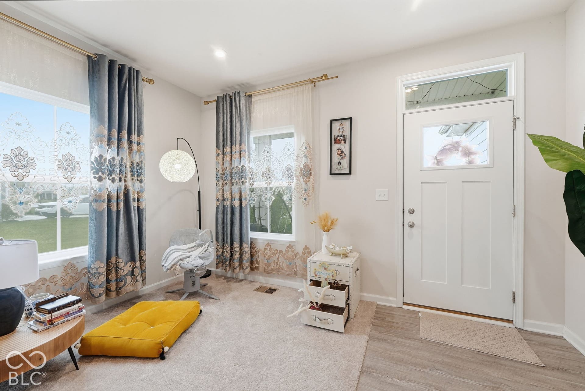275 Bohicket Road, Whiteland, IN 46184 Entryway featuring a white door with transom window, dual windows with gold-finish hardware, and a combination of neutral carpeting and wood-finish flooring