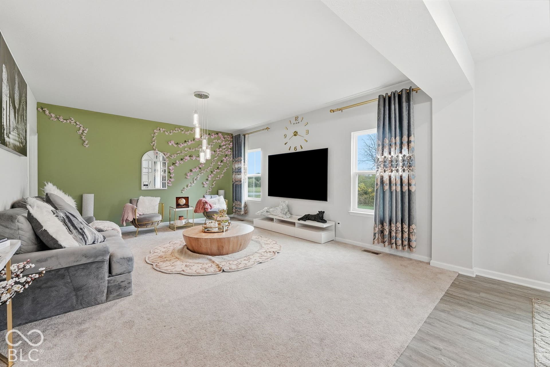 275 Bohicket Road, Whiteland, IN 46184 Neutral-toned carpeted flooring, accent wall, multi-pane windows, and modern pendant light fixture