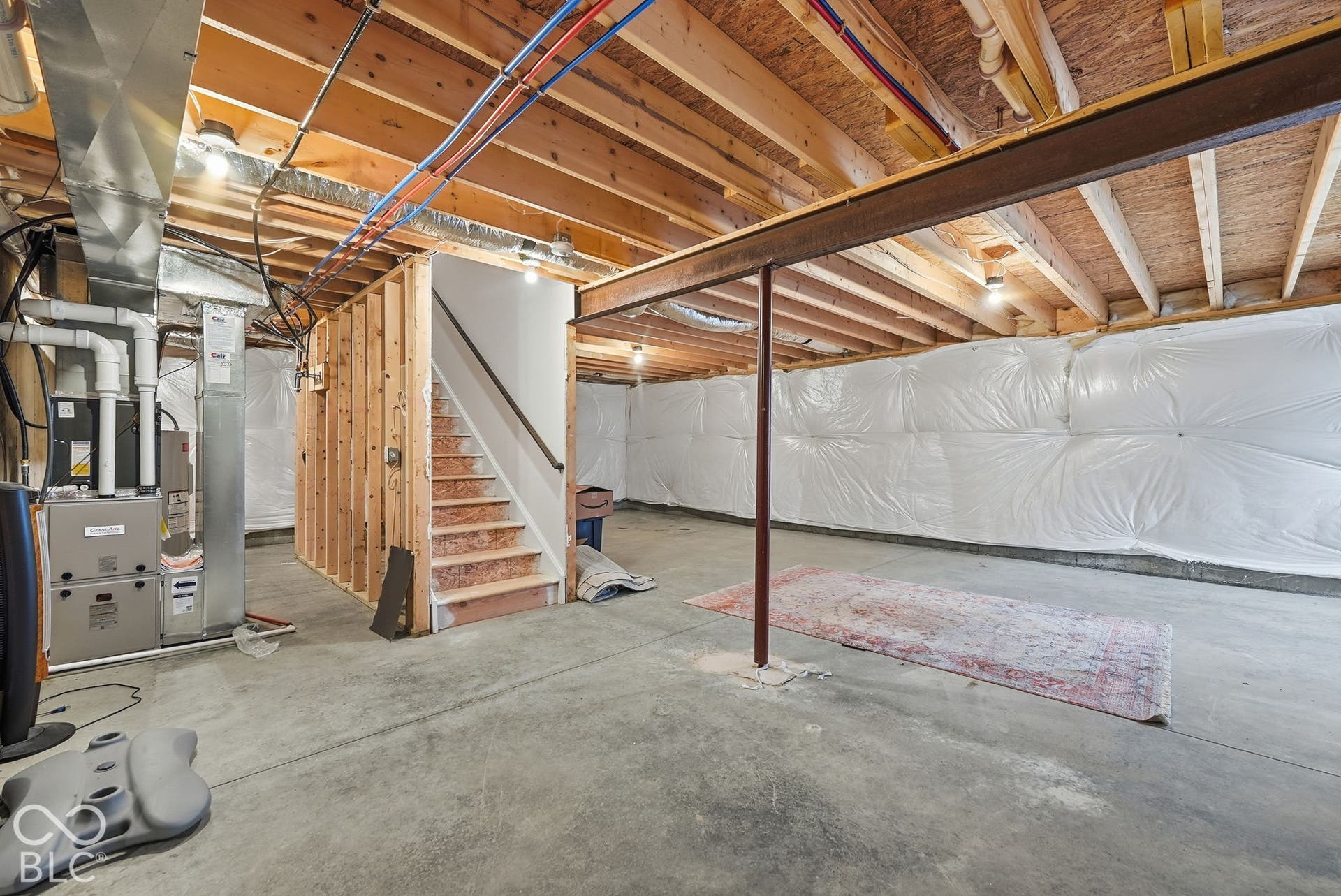 275 Bohicket Road, Whiteland, IN 46184 Unfinished lower level featuring concrete flooring, exposed wooden joists, structural steel support beam, and wall vapor barriers