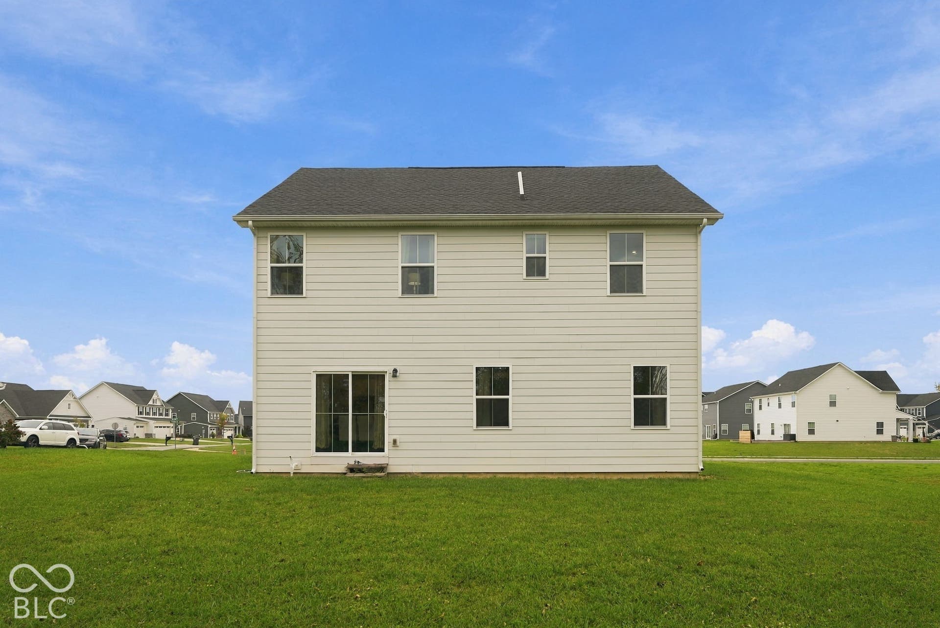275 Bohicket Road, Whiteland, IN 46184 Two-story exterior featuring light-colored horizontal siding, a pitched roof with asphalt shingles, and a sliding glass door