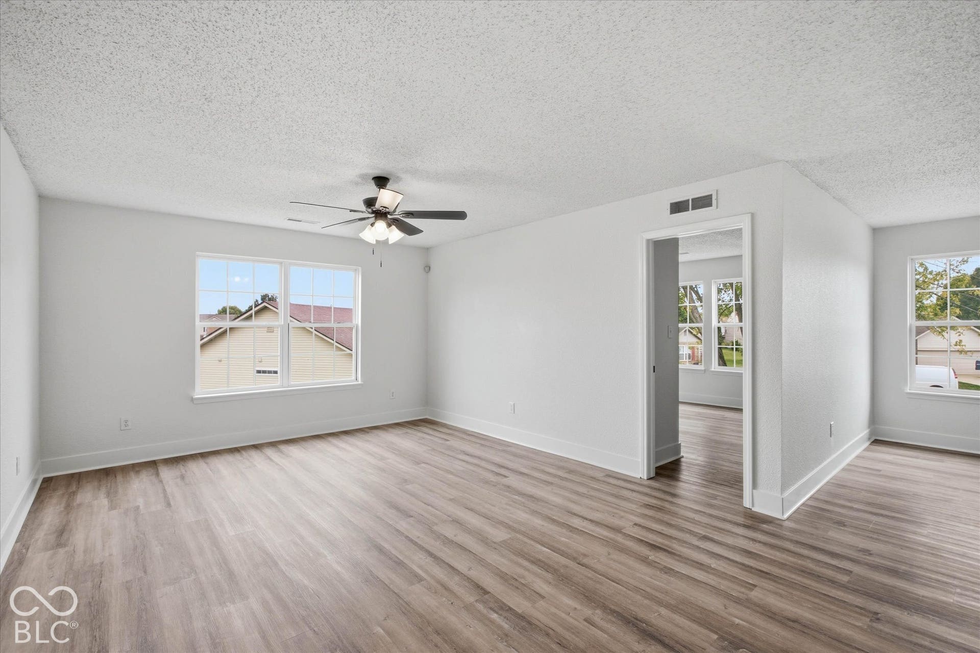 9607 Piper Lake Drive, Indianapolis, IN 46239 Neutral interior featuring wood-finish flooring, multi-pane windows, and a ceiling fan with integrated lighting