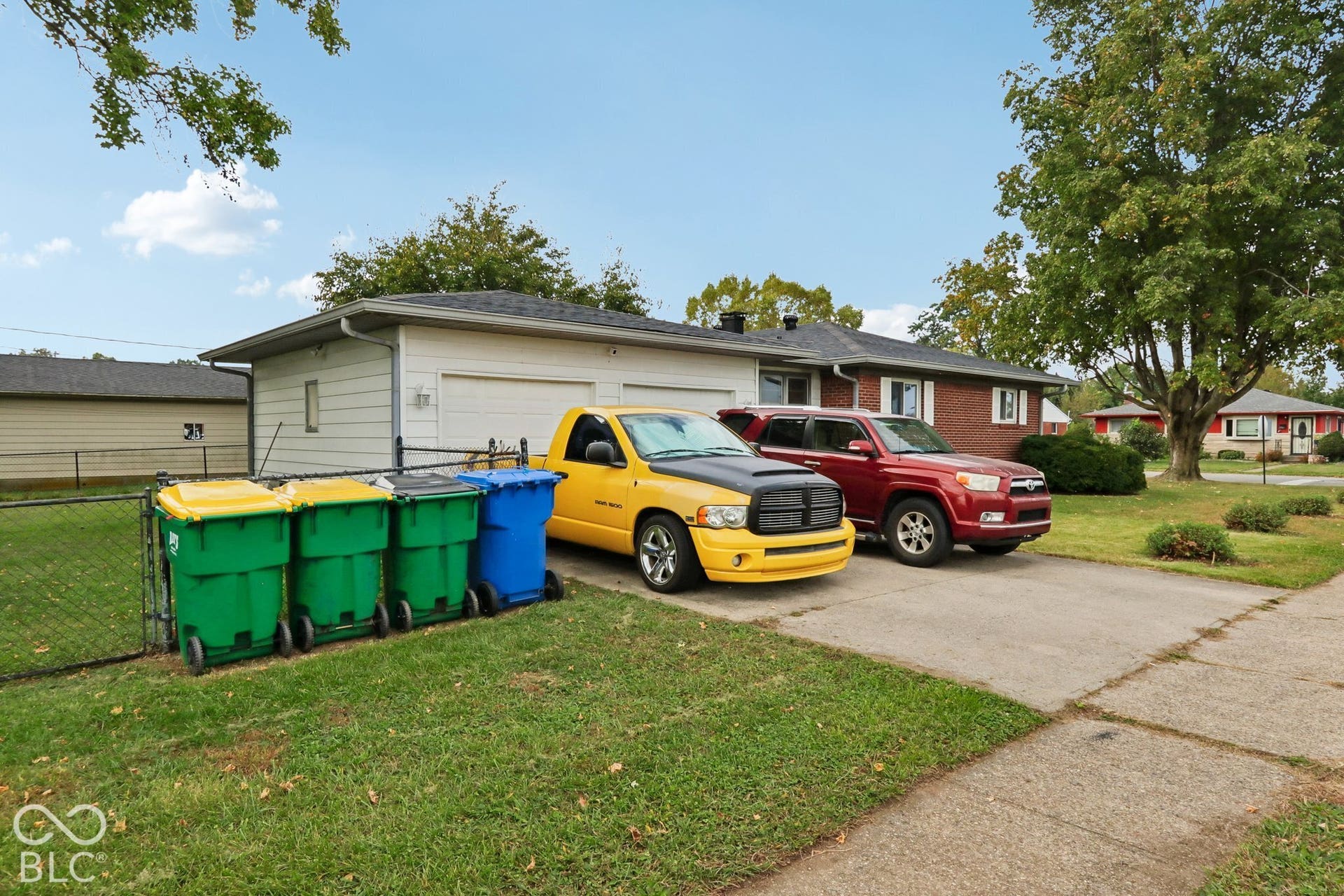 Single-story exterior featuring brick and horizontal siding, asphalt shingle roof, two-car garage, and concrete driveway