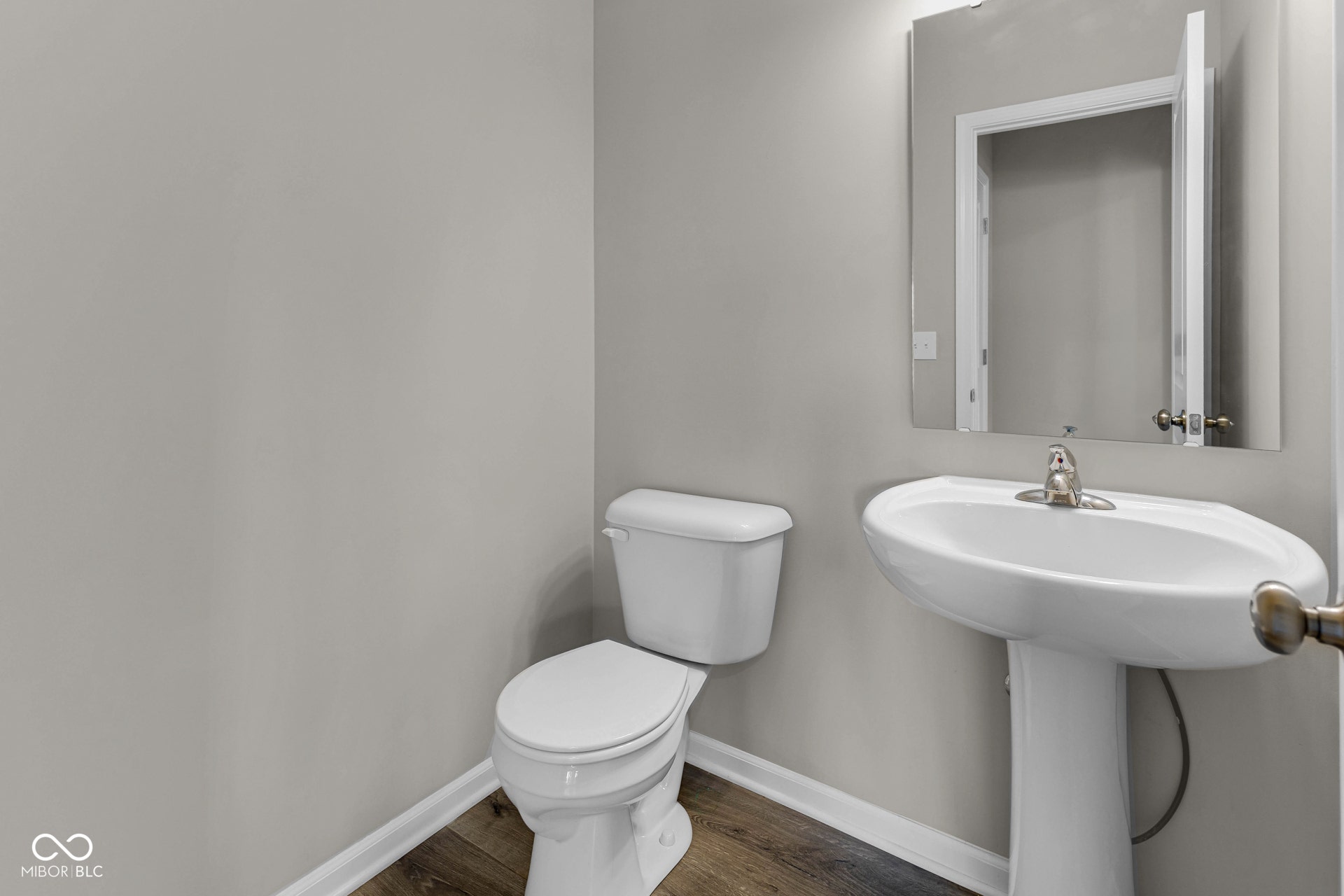 bathroom with toilet and wood finished floors