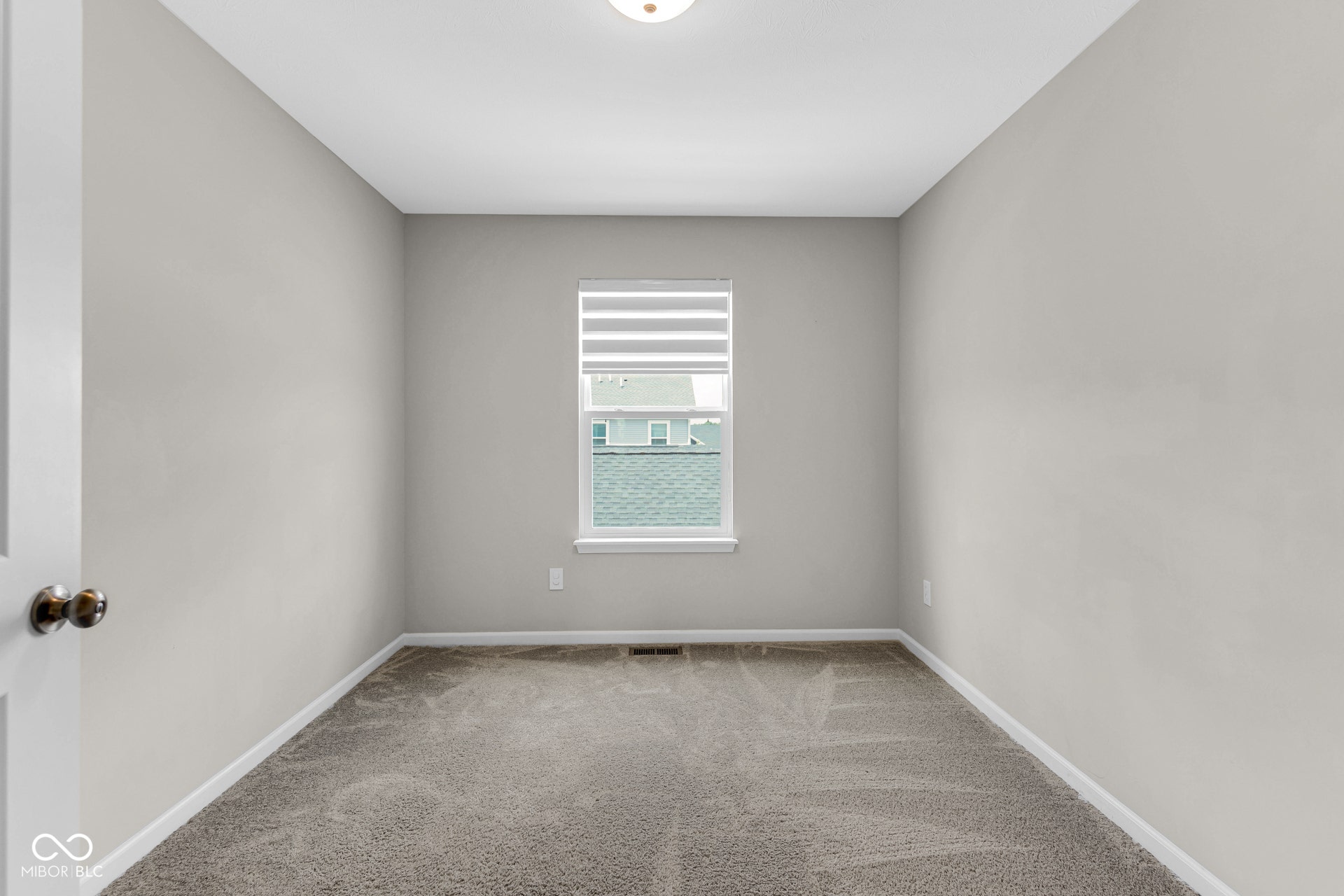 empty room with carpet and baseboards