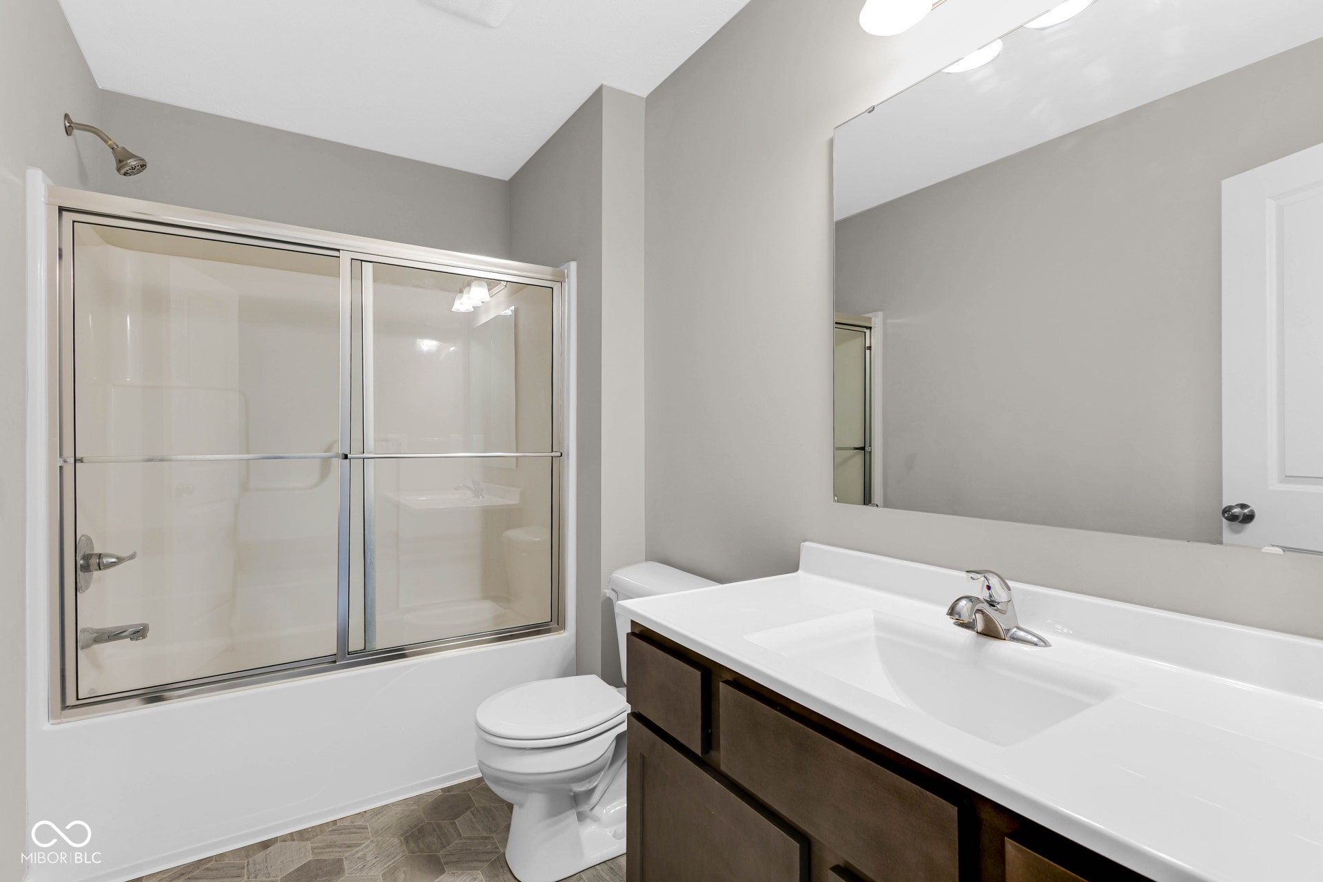 full bathroom with vanity and enclosed tub / shower combo