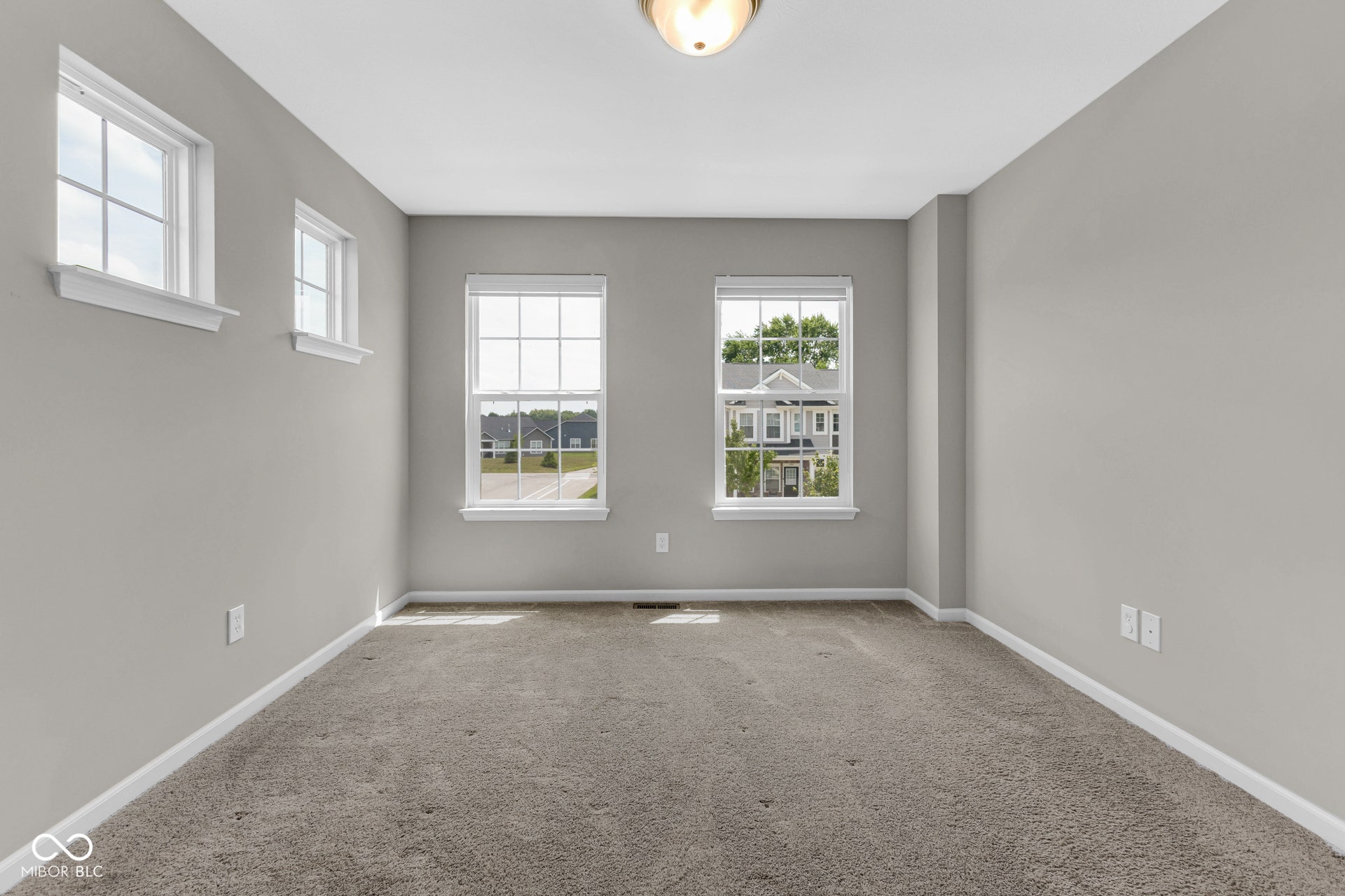 spare room with healthy amount of natural light and carpet