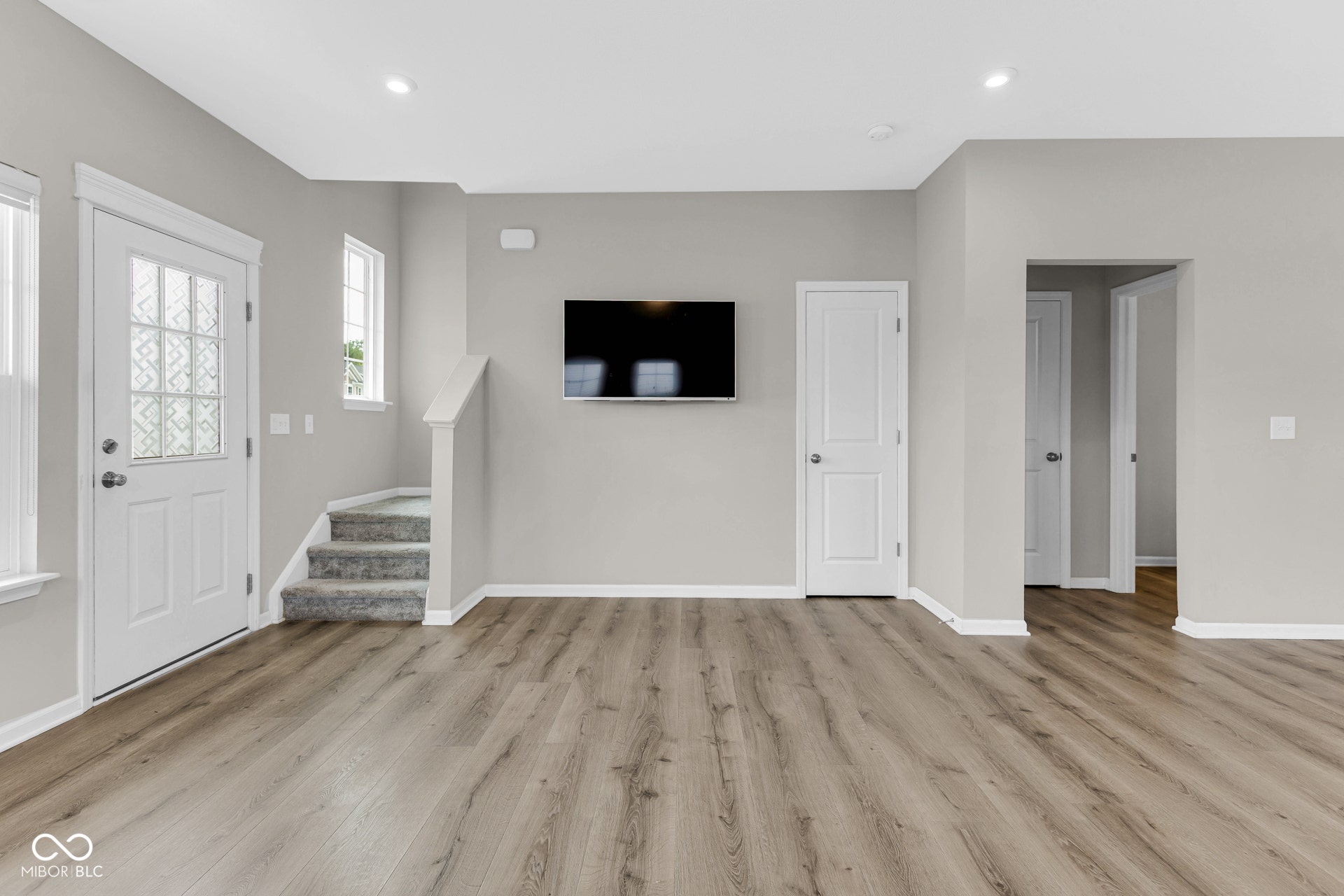 foyer featuring light wood-style floors, stairs, and recessed lighting