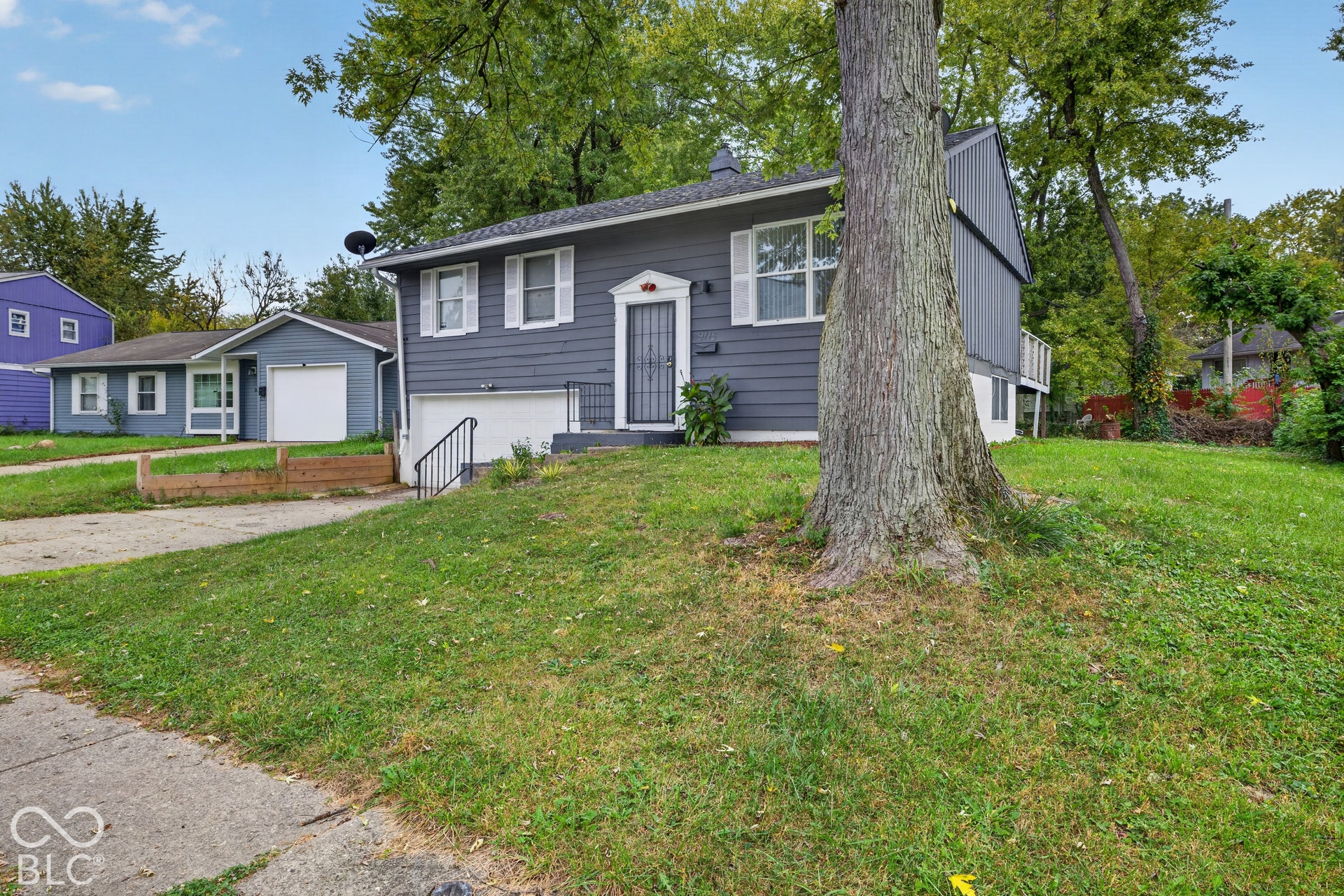 Exterior featuring horizontal lap siding, a concrete driveway, an attached garage, and white-trimmed windows
