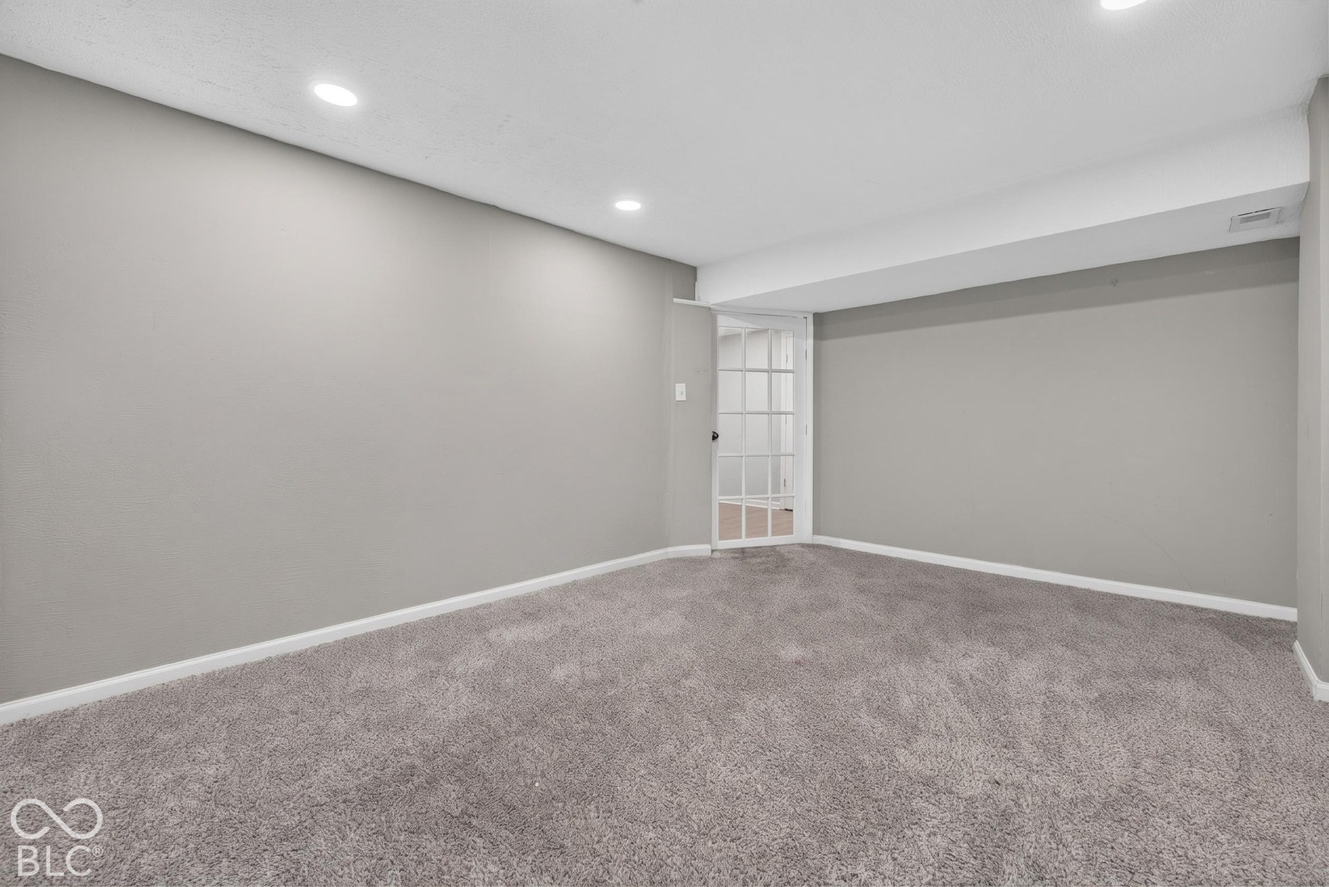 Neutral interior space featuring recessed lighting, wall-to-wall carpeting, and a French door with glass panes
