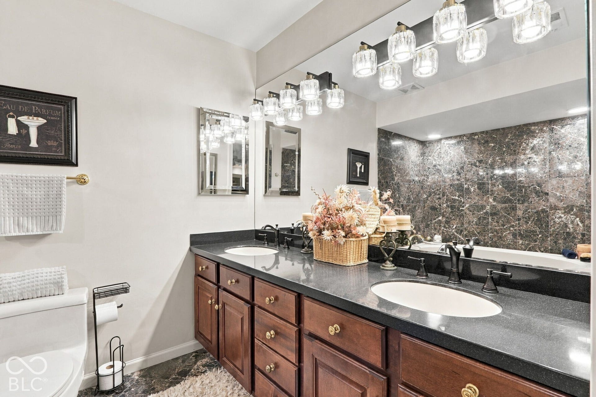 Luscious primary bath with dual sinks and plenty of lighting.