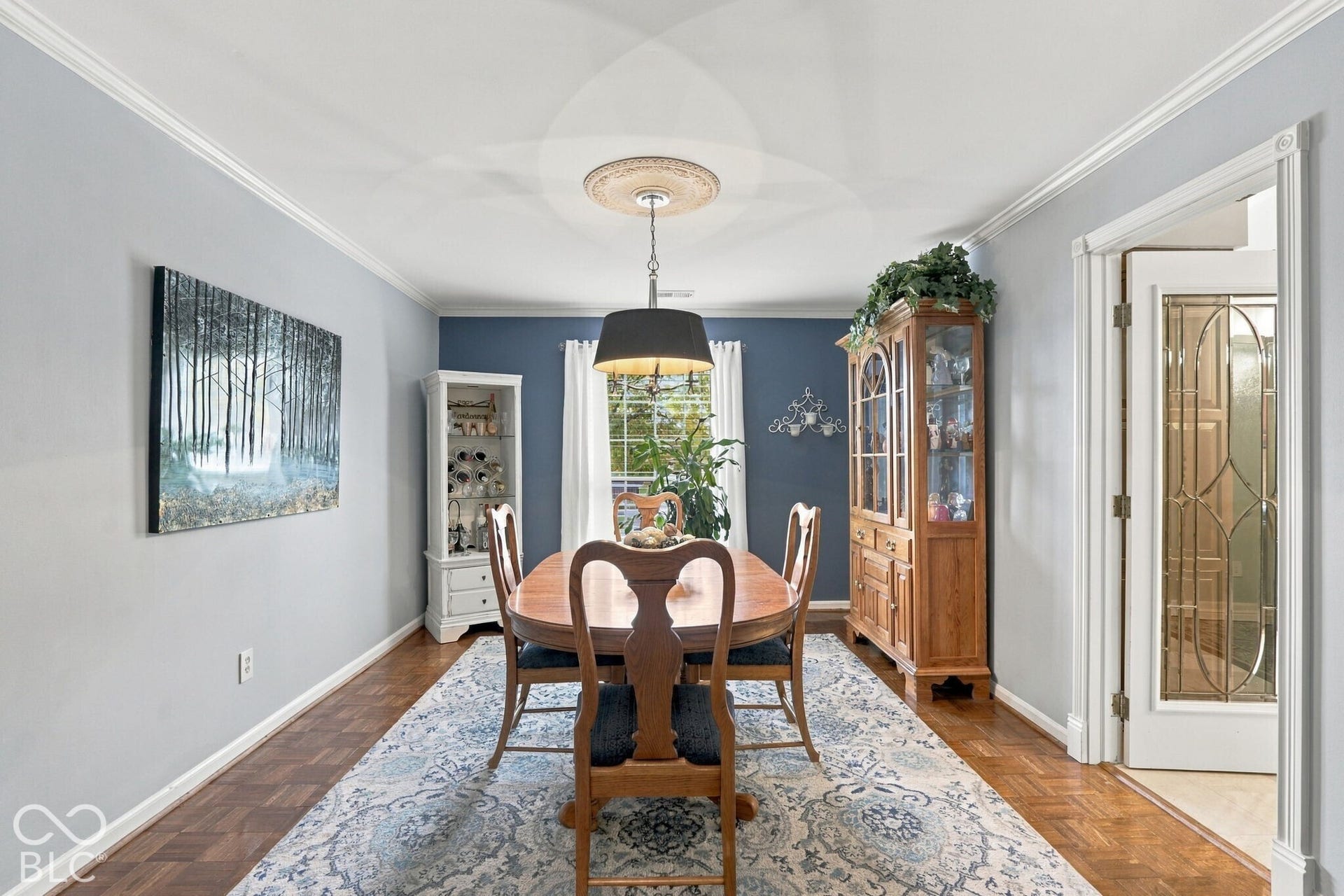 It looks right out of a magazine! Parquet floors, neutral tones, nice light fixture and plenty of light from your window.