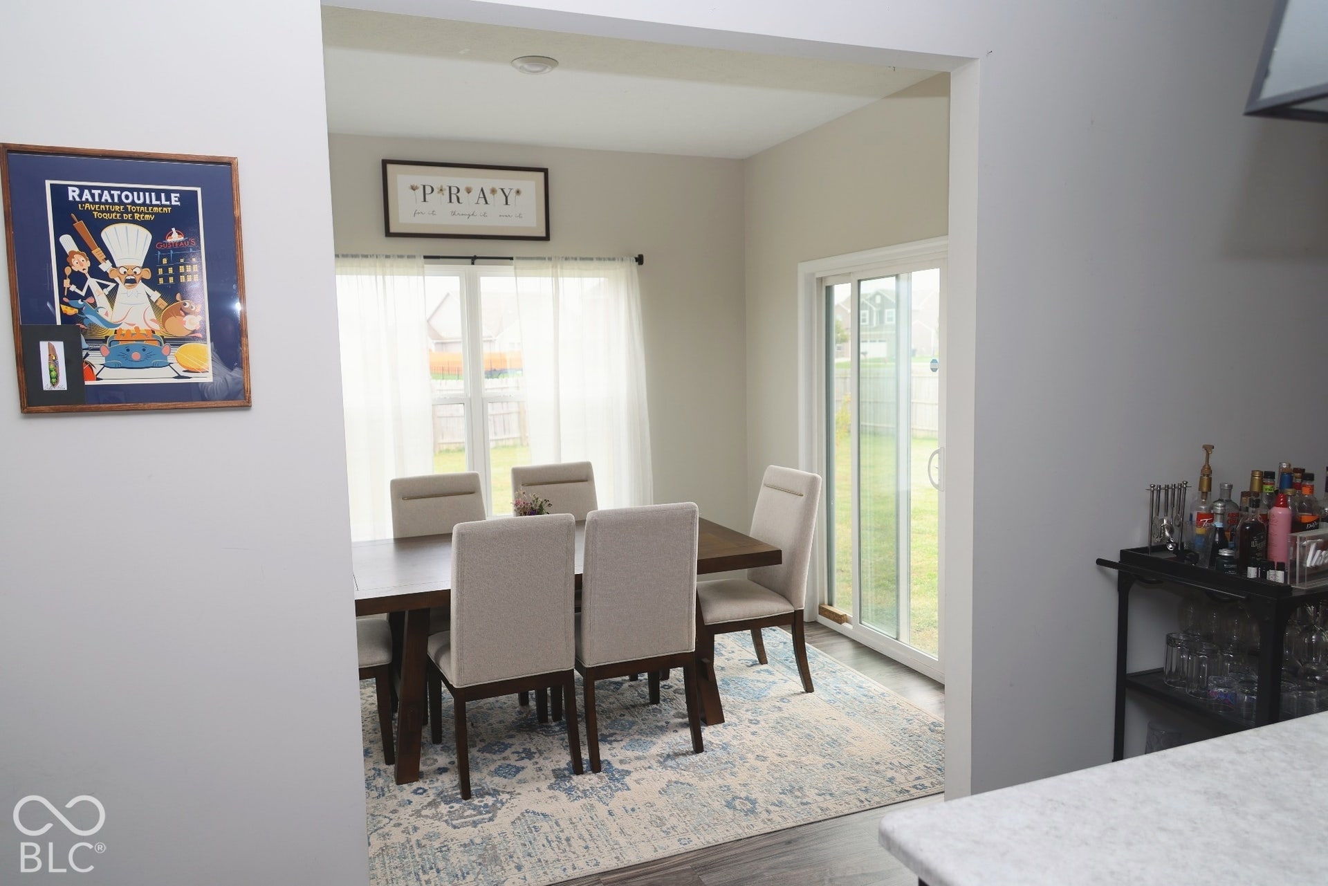 Dining area featuring dual-pane window, glass sliding door, and neutral wall tones
