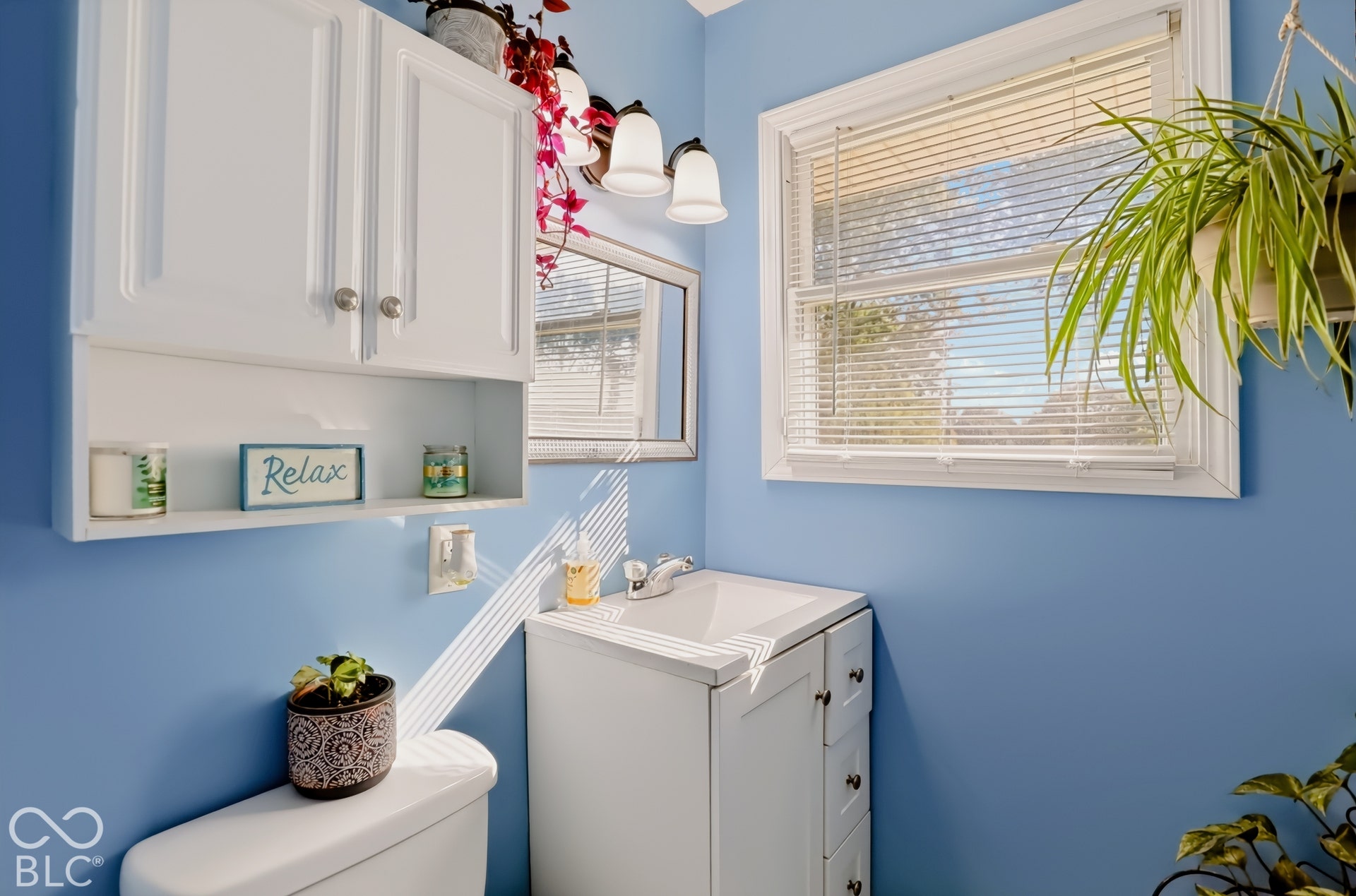 White vanity featuring a built-in sink and integrated storage drawers, topped with a chrome faucet