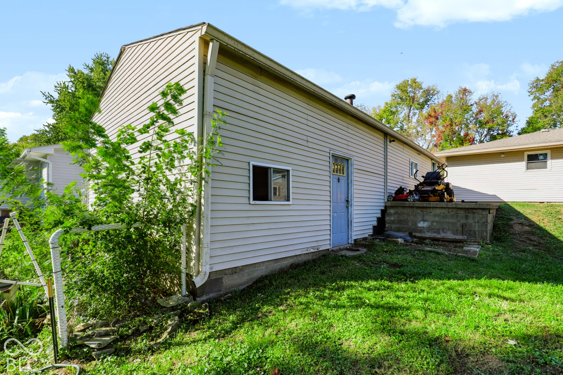 Exterior featuring horizontal siding, a concrete foundation, and a raised masonry platform
