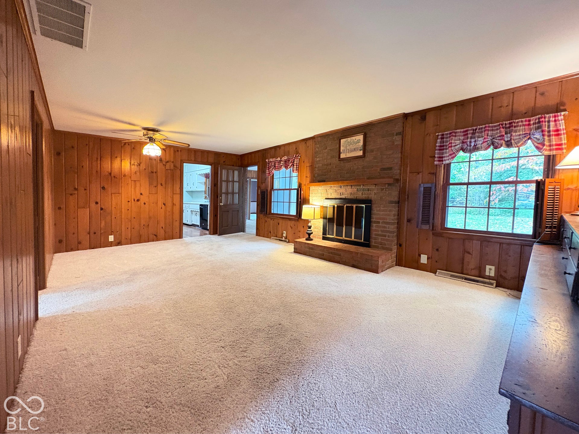 Family room, 22' x 13' has fireplace, built in bookshelves, and room for a game table.