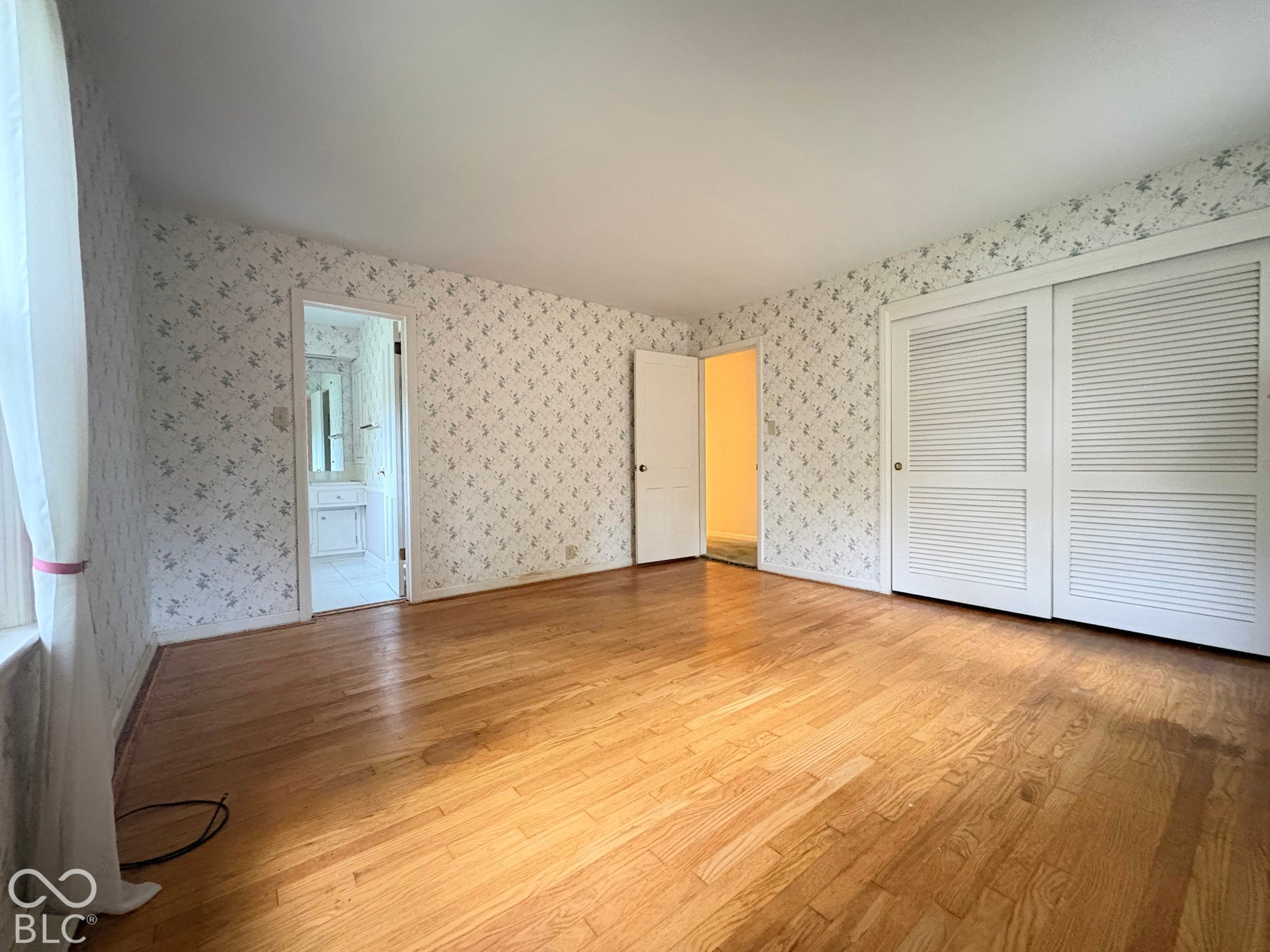 The carpeting has been removed so buyer can see quality of the hardwood floors.