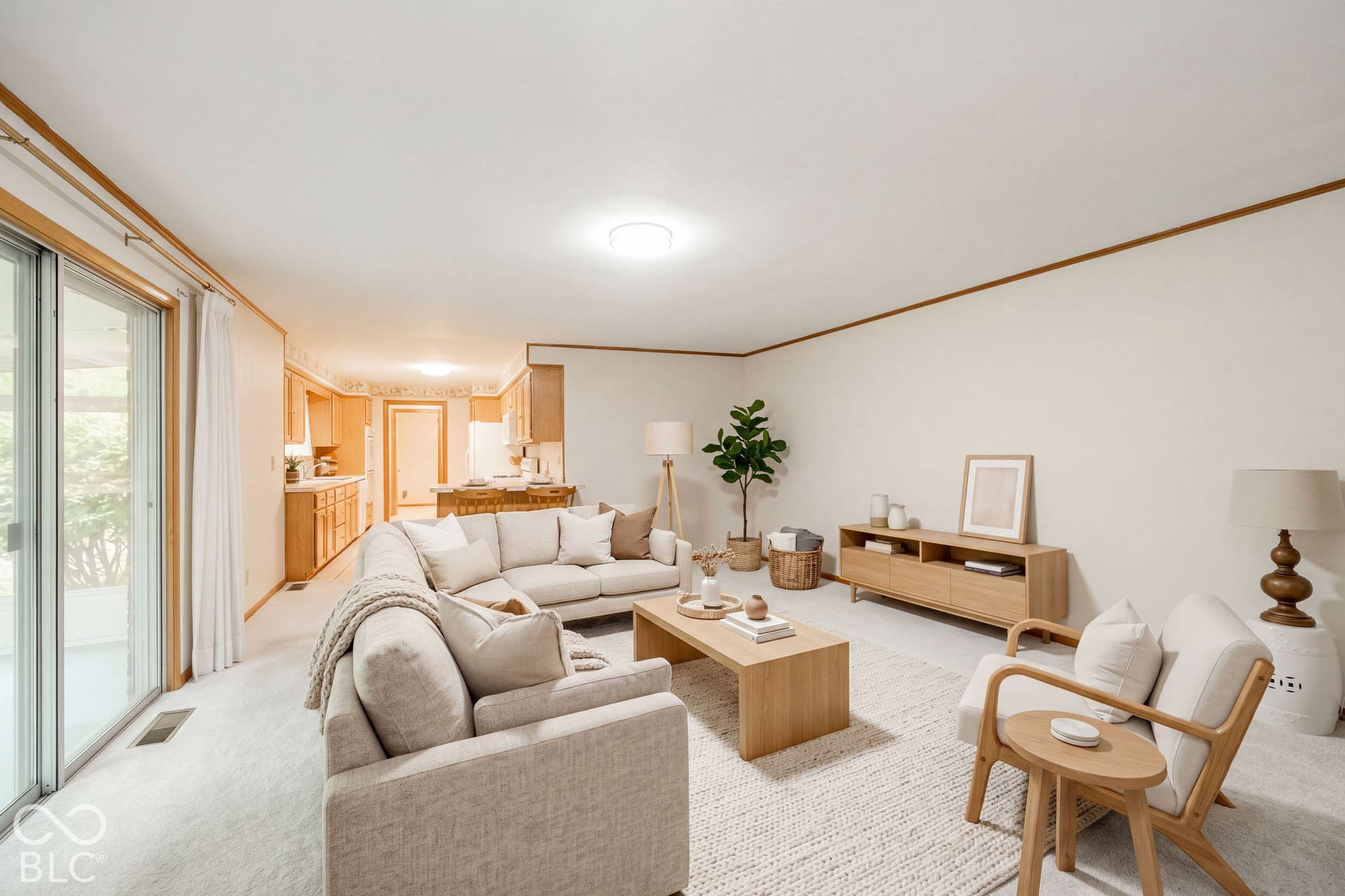 Virtually Altered - Open-concept interior featuring wall-to-wall carpeting, sliding glass doors, and crown molding. Virtually Staged.