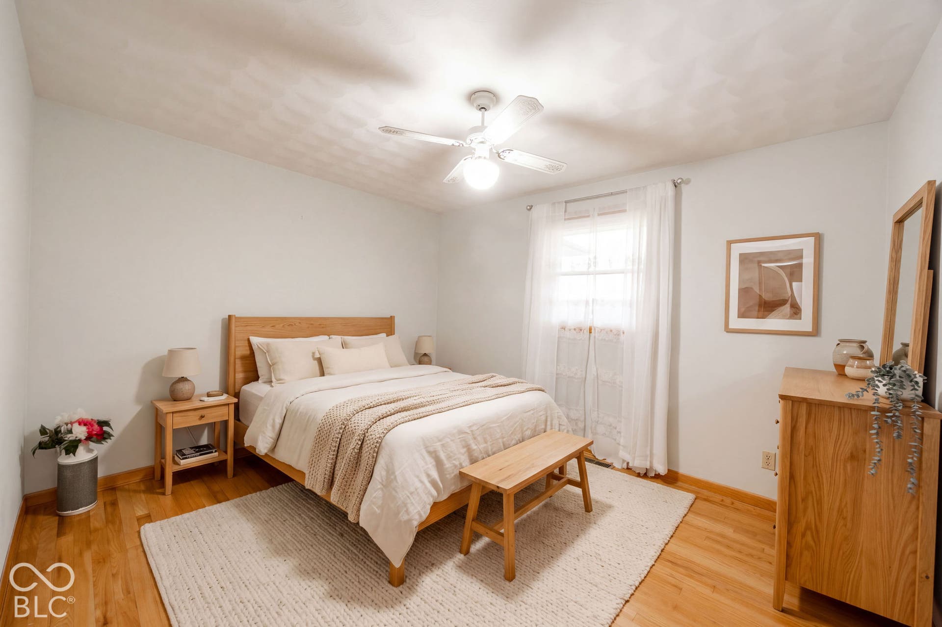 Virtually Altered - Room featuring wood-finish flooring, a central ceiling fan with integrated lighting. Virtually Staged.
