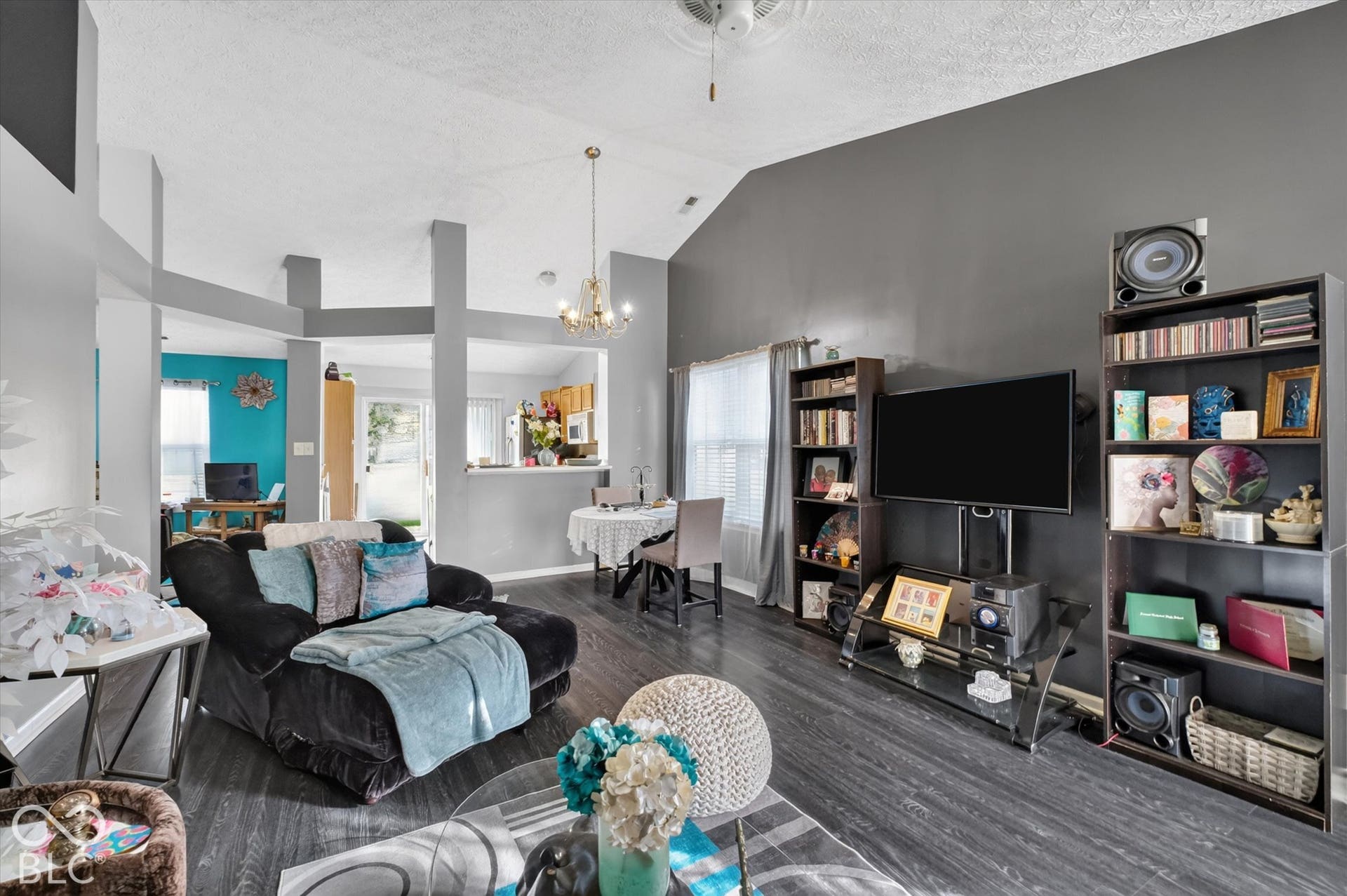 Vaulted ceilings, wood-finish flooring, and a multi-tiered structural partition
