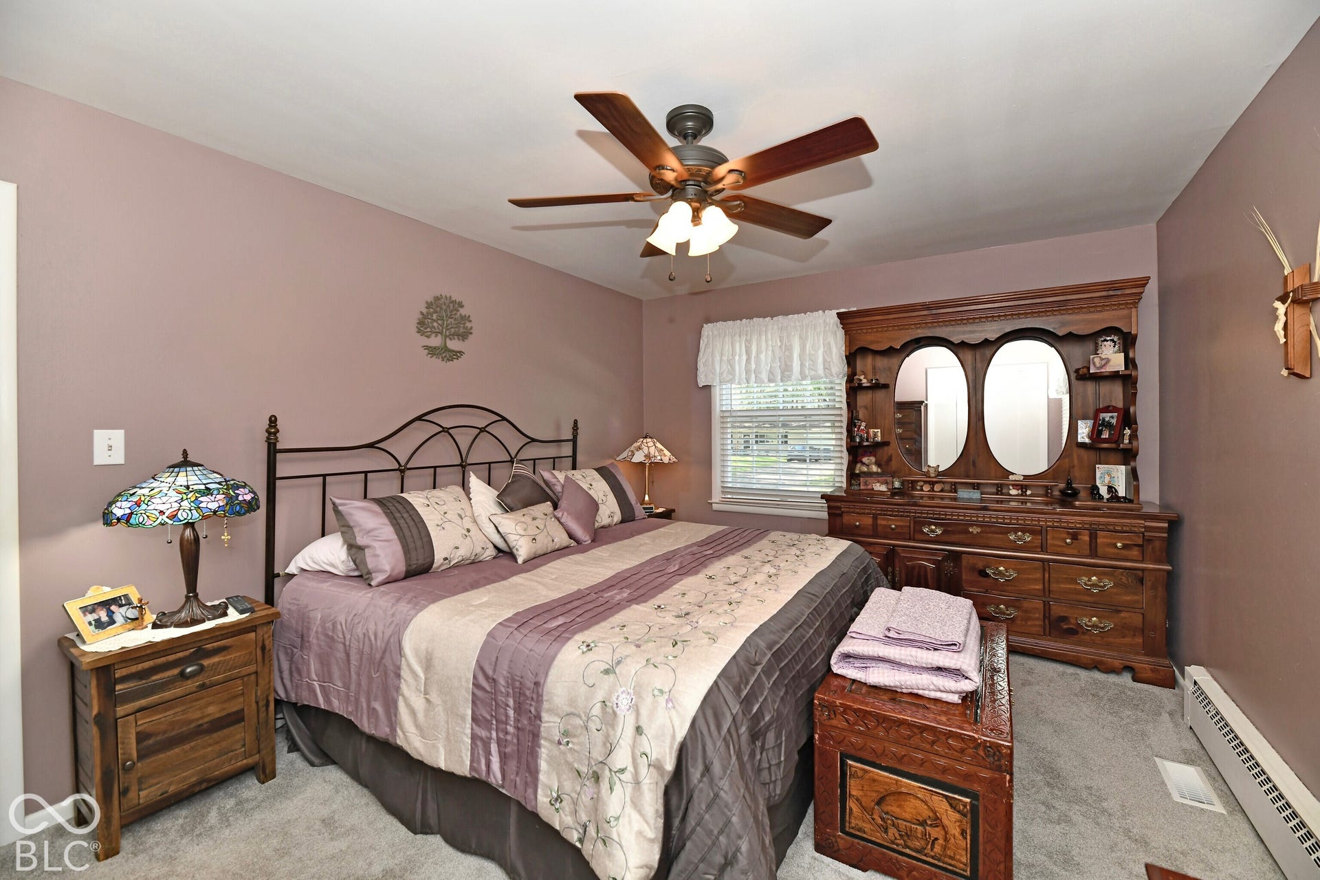 Bedroom featuring neutral-toned walls, carpeting, a multi-blade ceiling fan with an integrated light fixture, and a single-pane window