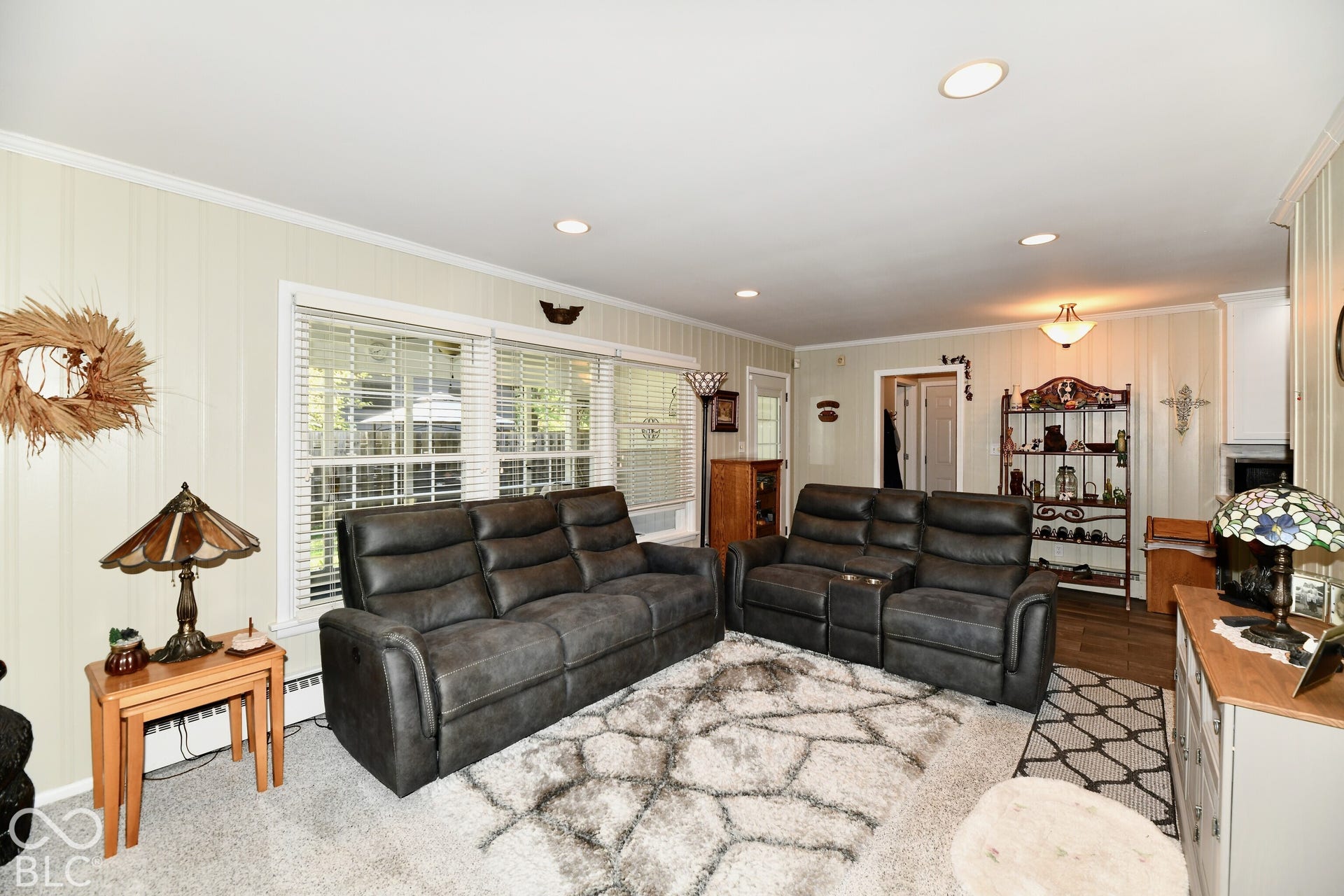 Living area featuring recessed lighting, paneled walls, and expansive triple-pane window installation