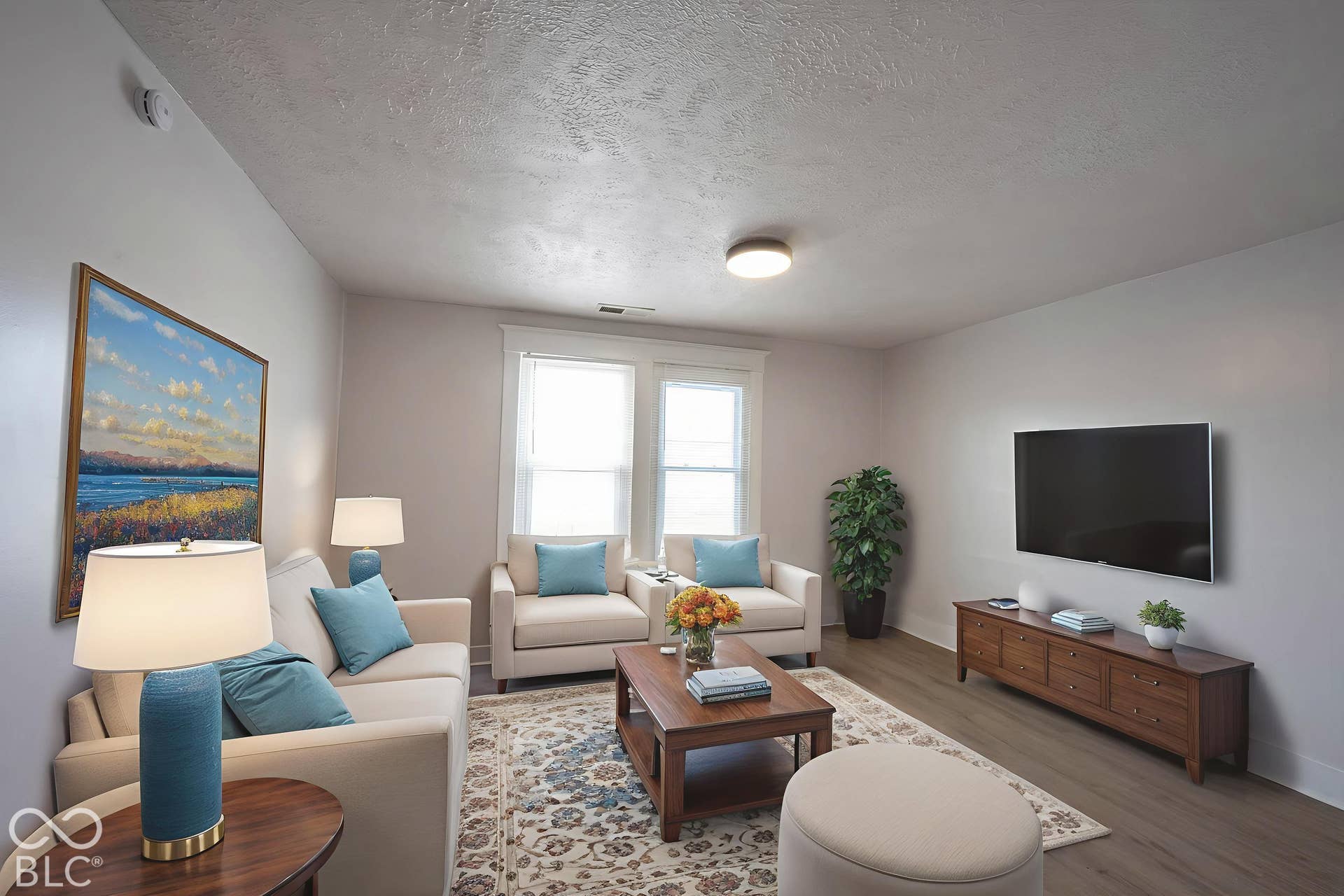 Virtually Altered - Living area featuring wood-finish flooring, dual-pane windows, and a central ceiling light fixture