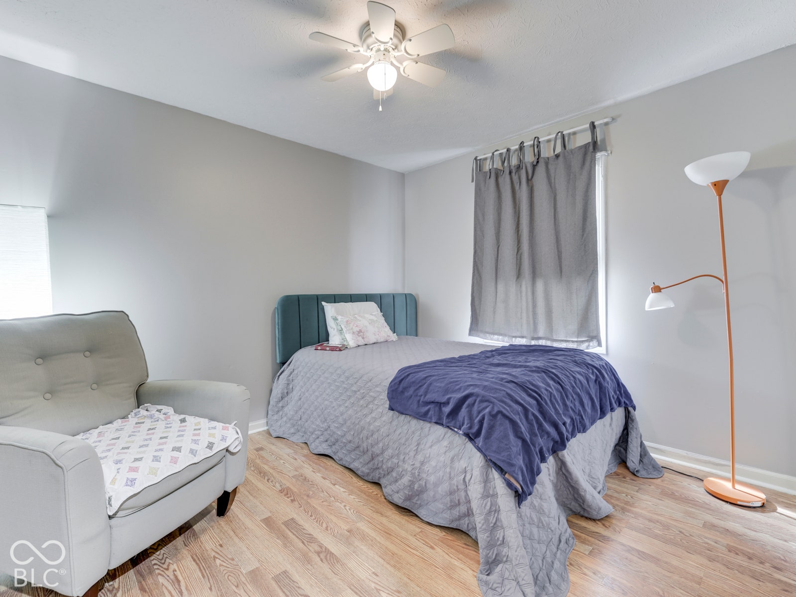 770 Ivy Lane, Greenwood, IN 46143 Room featuring wood-finish flooring, neutral wall paint, and a ceiling-mounted light fixture with a multi-blade fan