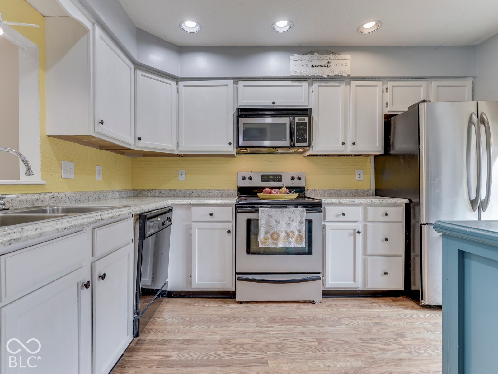 770 Ivy Lane, Greenwood, IN 46143 Kitchen featuring white cabinetry, light-toned countertops, stainless steel appliances, and recessed lighting