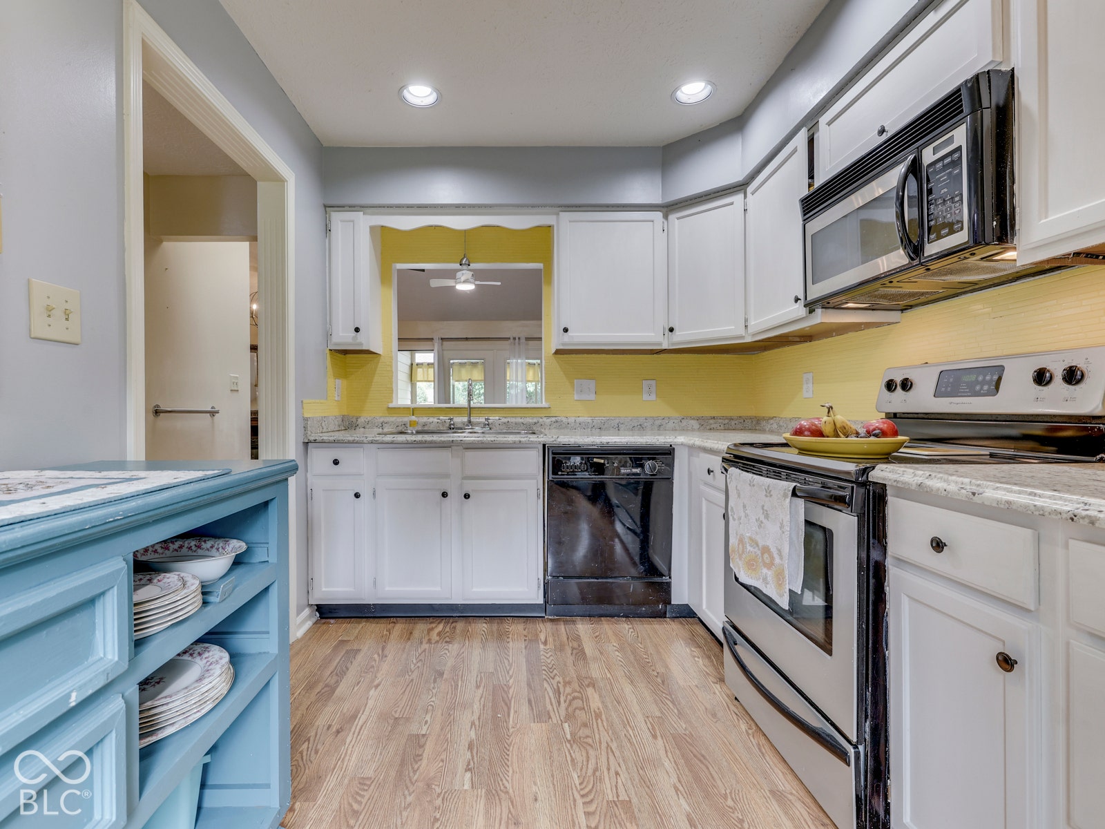 770 Ivy Lane, Greenwood, IN 46143 Kitchen featuring white cabinetry, stone-surface countertops, stainless steel appliances, wood-finish flooring, and recessed lighting