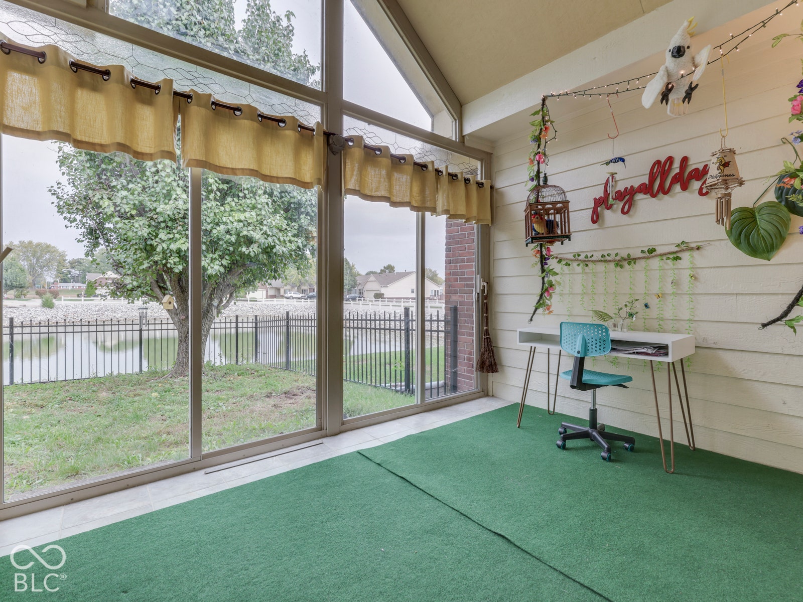 770 Ivy Lane, Greenwood, IN 46143 Sunroom featuring floor-to-ceiling windows, vaulted ceilings, and horizontal plank wall paneling
