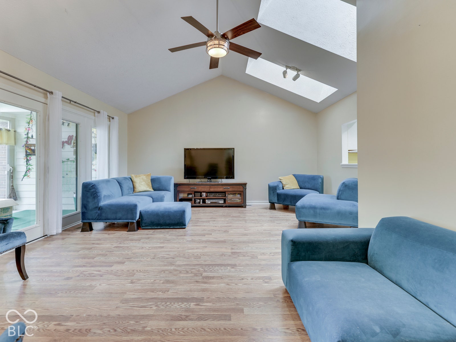 770 Ivy Lane, Greenwood, IN 46143 Vaulted ceiling featuring skylights, wood-finish flooring, and a ceiling fan with integrated lighting