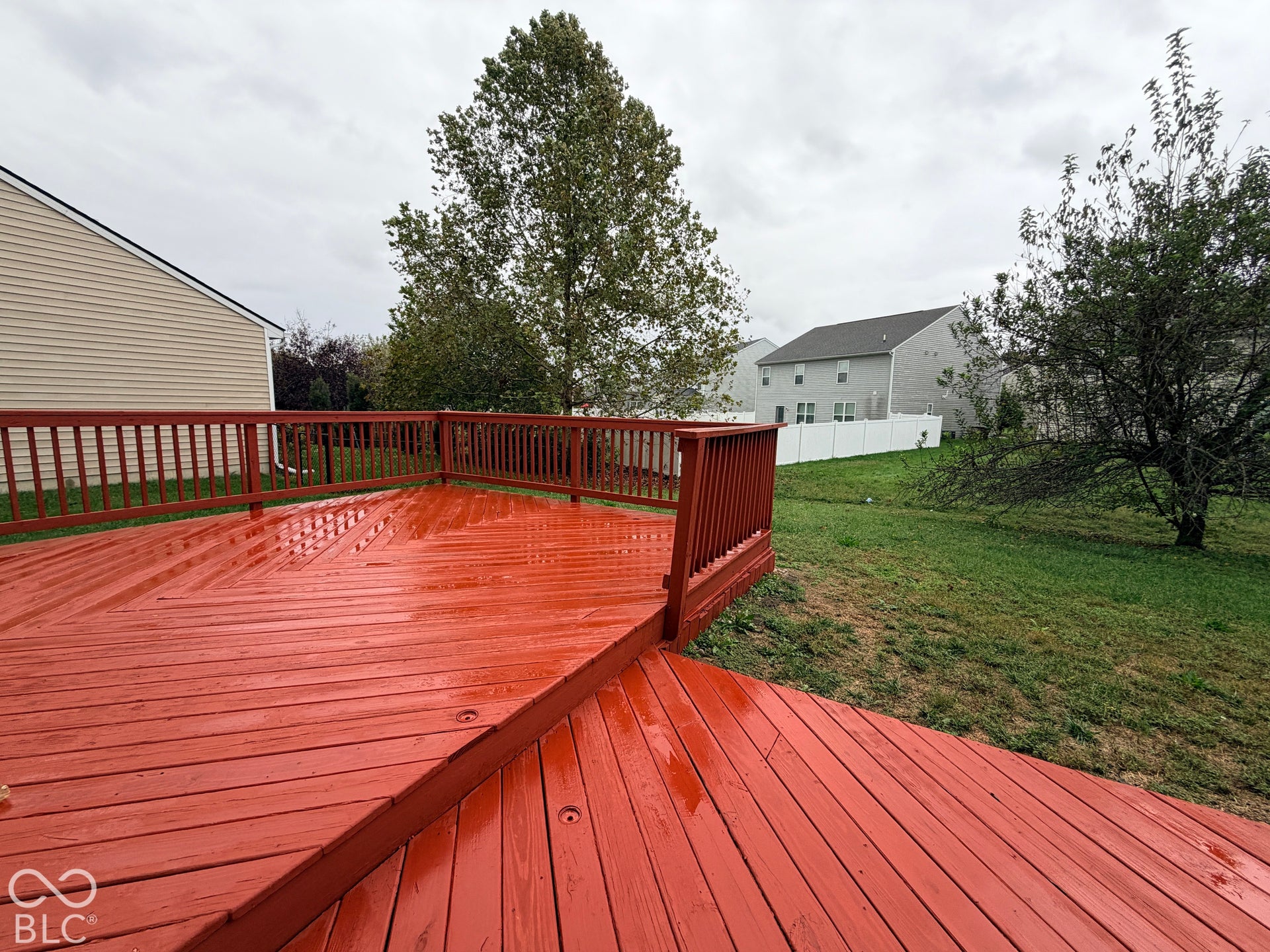 Multi-level wooden deck featuring a diagonal board pattern and perimeter railing